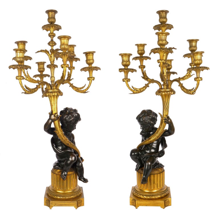 Superb pair of dore and patinated bronze seven-light candelabra with putto figural
France, circa 1870-1890
Item # 007LTX30A 

An incredibly fine pair of seven-light doré and patinated bronze candelabra, both feature putto figurals with seated