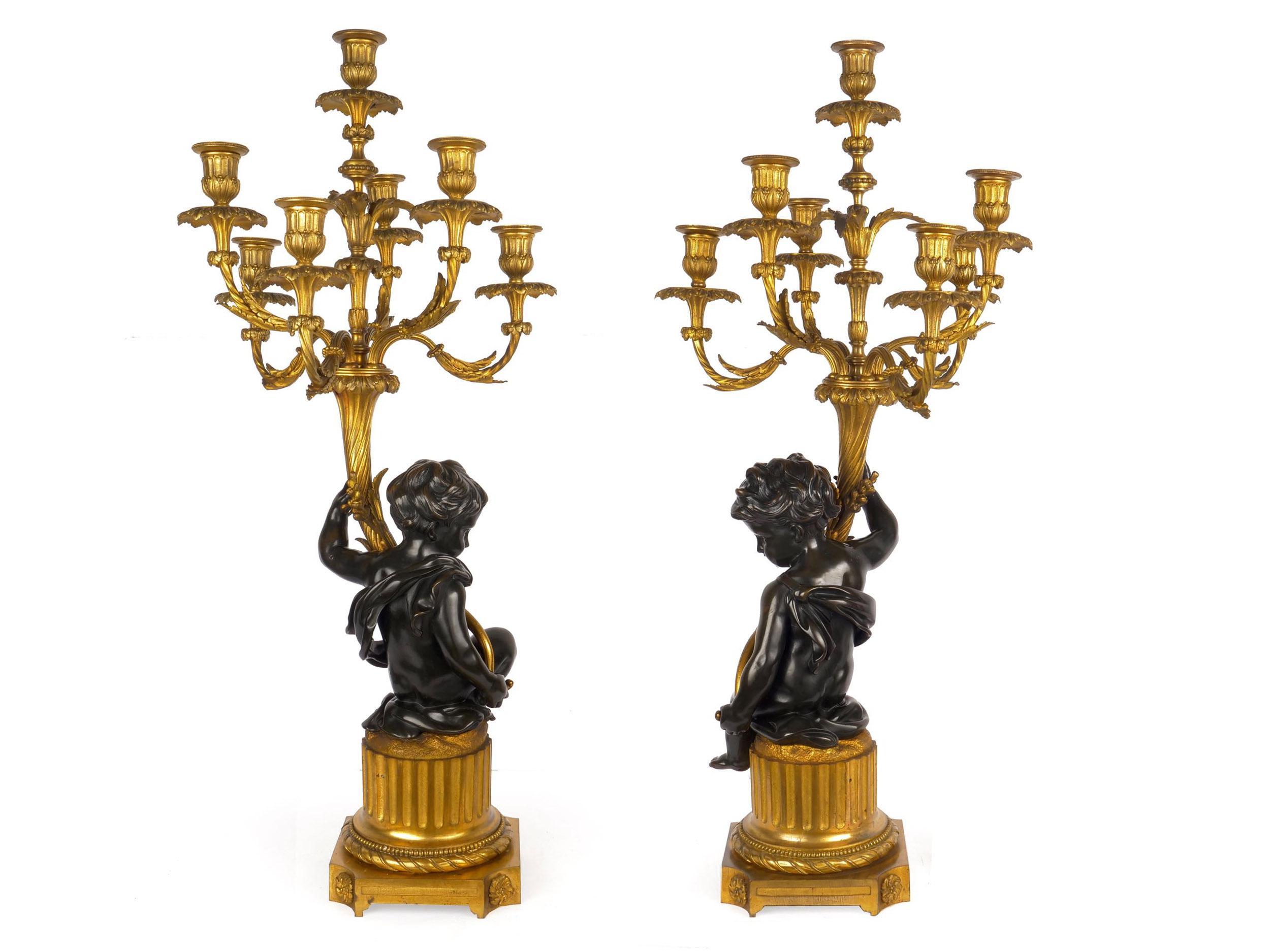 SUPERB PAIR OF DORÉ AND PATINATED BRONZE SEVEN-LIGHT CANDELABRA WITH PUTTO FIGURALS
France, circa 1870-1890
Item # 007LTX30A 

An incredibly fine pair of seven-light doré and patinated bronze candelabra, both feature putto figurals with seated