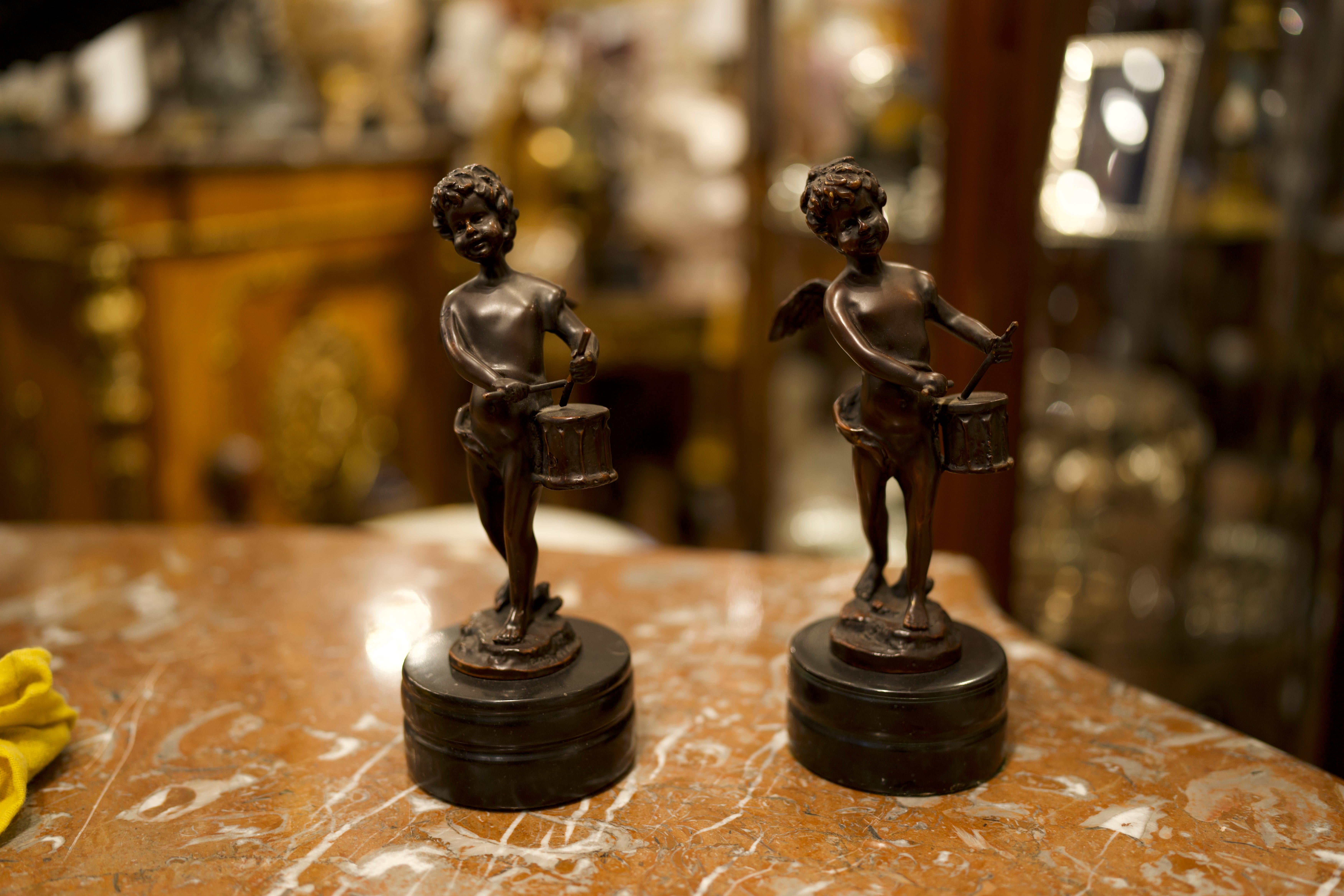 Pair of French Bronze Cherubs sculptures playing the drums. Perfect for home decor and interior design.
