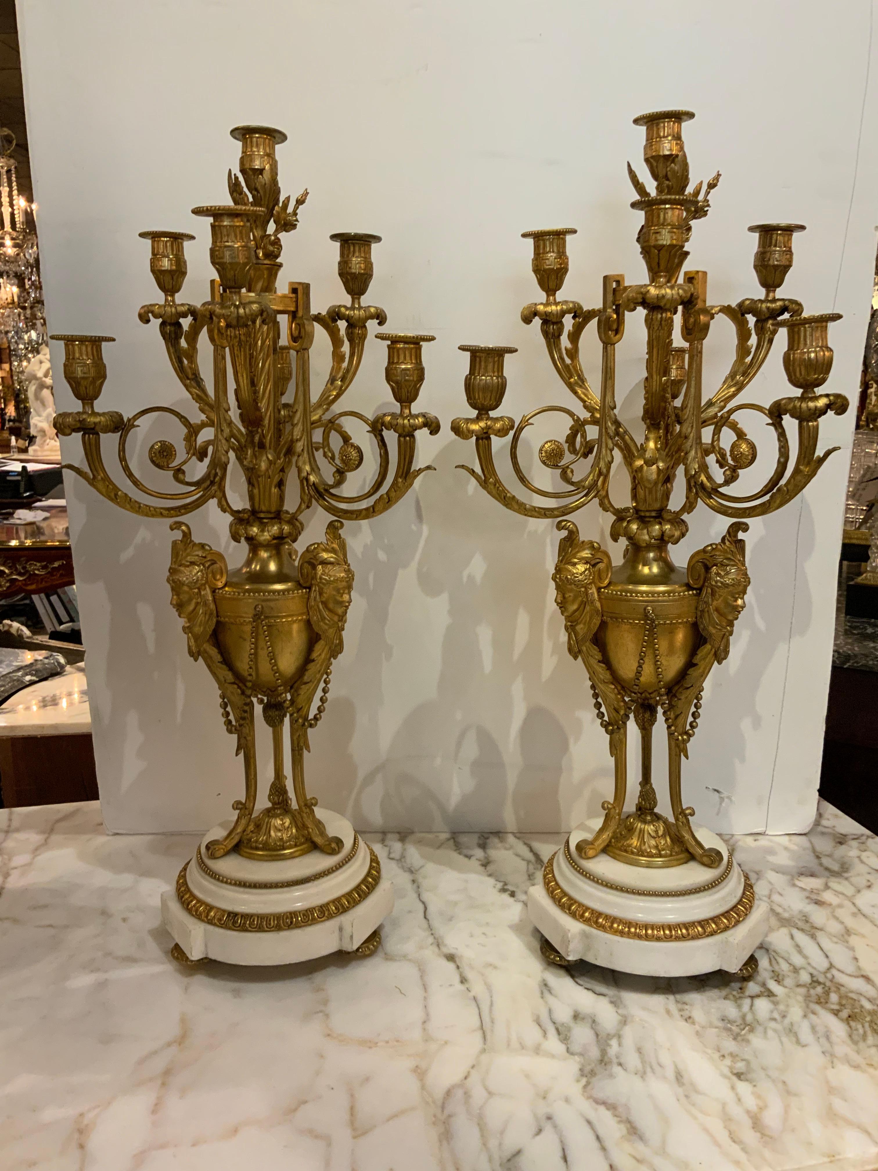 Exceptional pair of French candleabrum in bronze dore
Set on Carrara marble bases. These candleabrum are
Complete without any missing parts. They each have
Seven candle holders complete with bobesches.
The patina of the bronze is a soft gilt hue