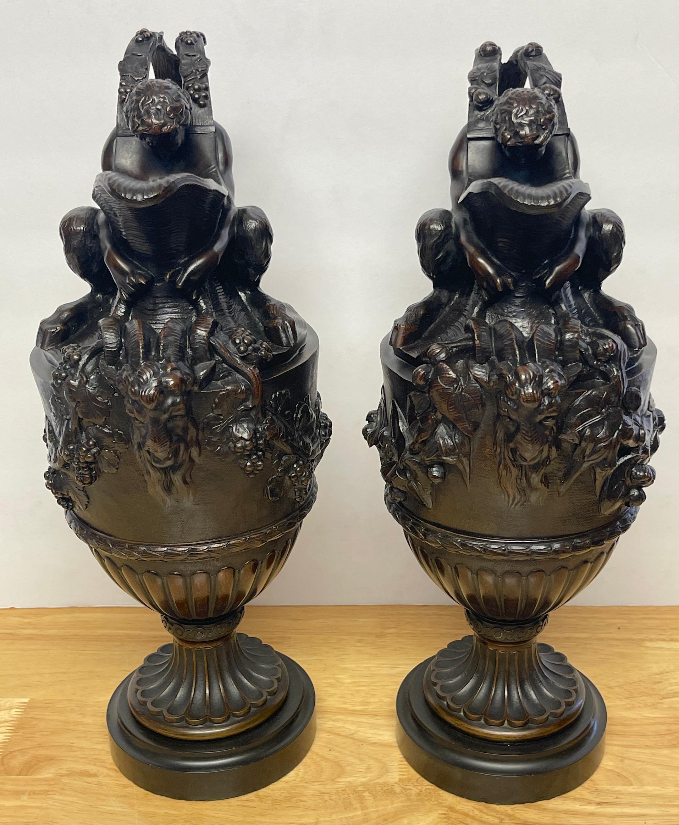 Patinated Pair of French Bronze Figural Ewers in the Manner of Claude Michael Clodion