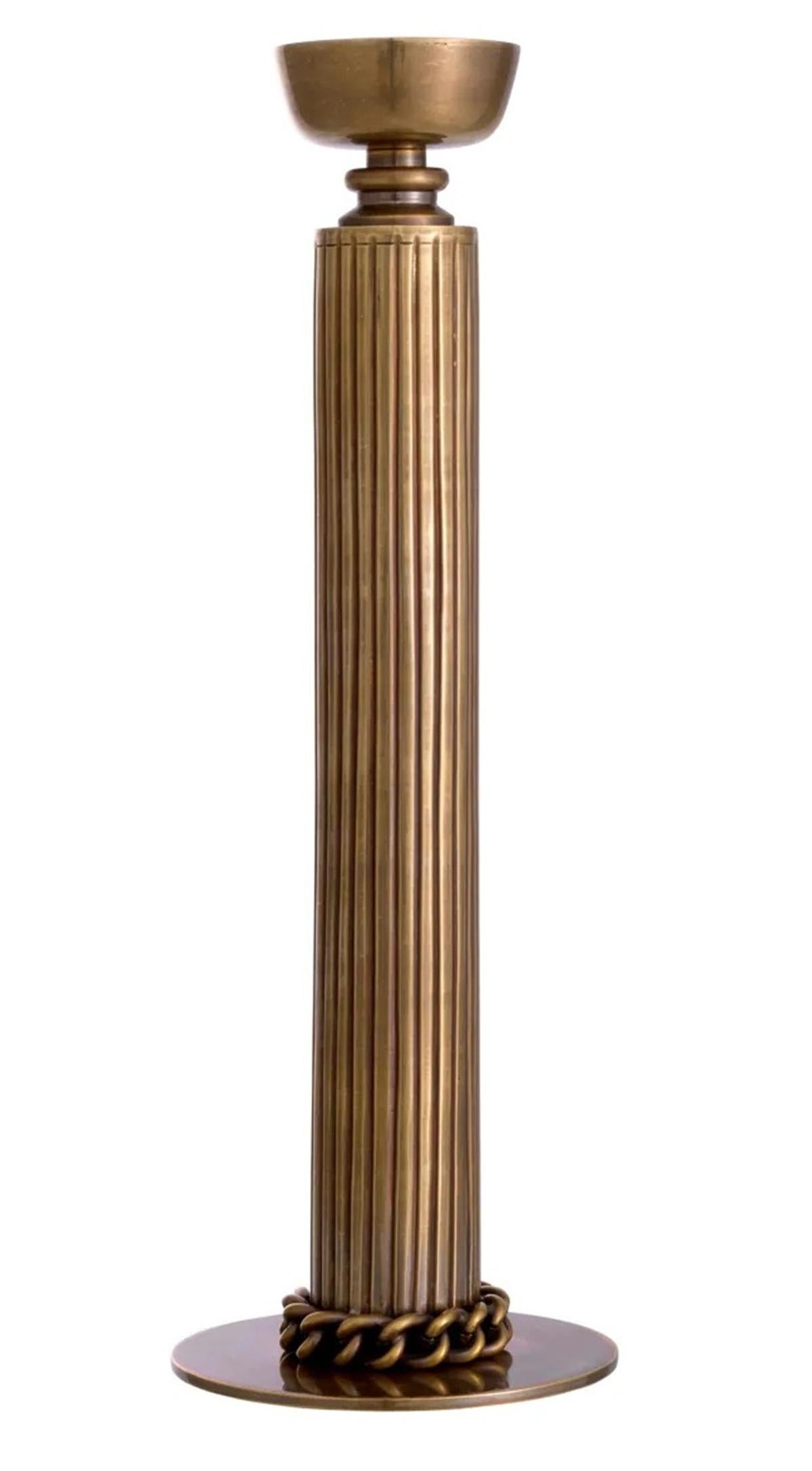Illuminate your surroundings with the warm glow of Candle, beautifully accentuated by the vintage appeal of the Le Dôme Candle Holder Crafted with meticulous artistry, this exquisite piece boasts a vintage brass finish that exudes an air of regal