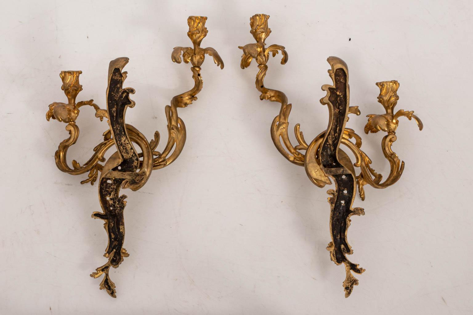 Pair of French two light sconces with foliage detail, circa 1930s. Please note of wear consistent with age. Shades not included. Made in France.