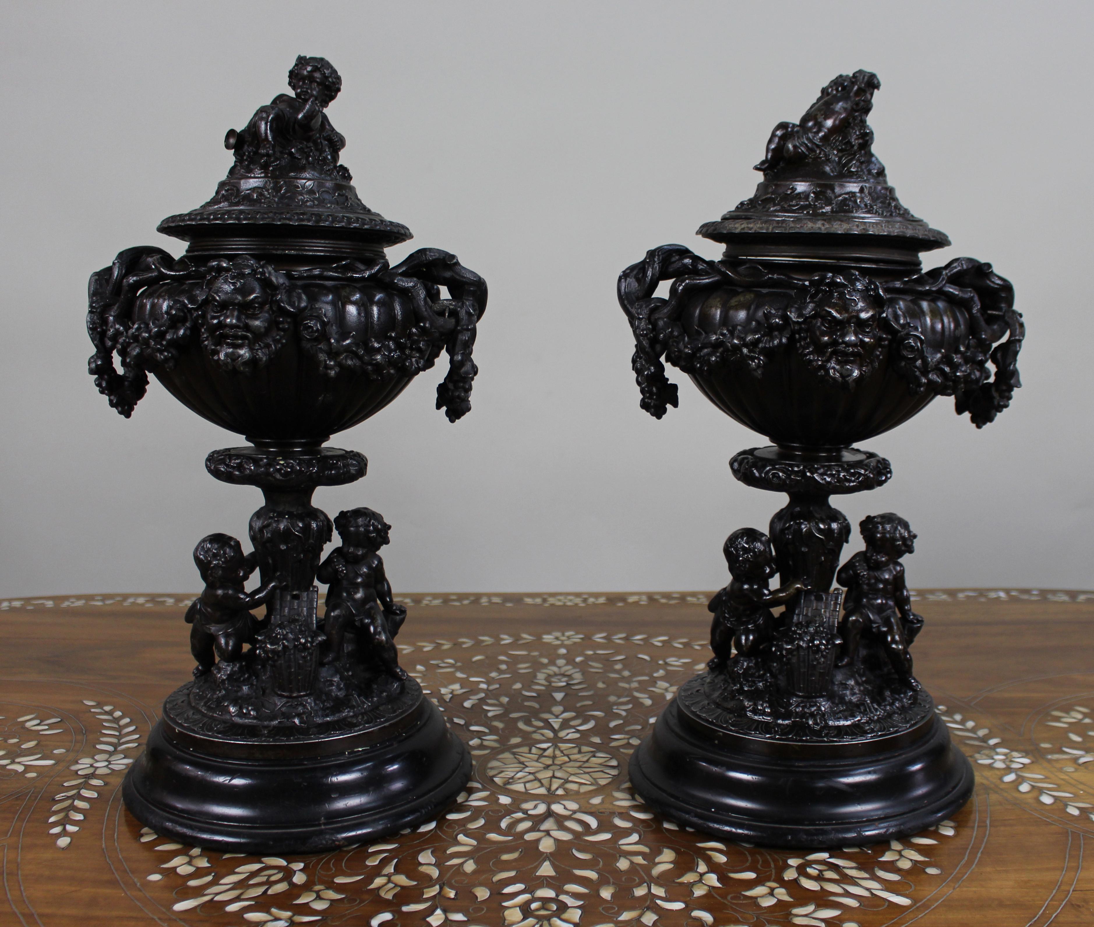 Pair of French Bronzed Spelter Urns with Bacchic Masks and Putti, Circa 1880


A decorative and finely modelled pair of late 19th-century French urns, cast in spelter with a dark bronze patination.

Each urn of lobed baluster form, mounted with