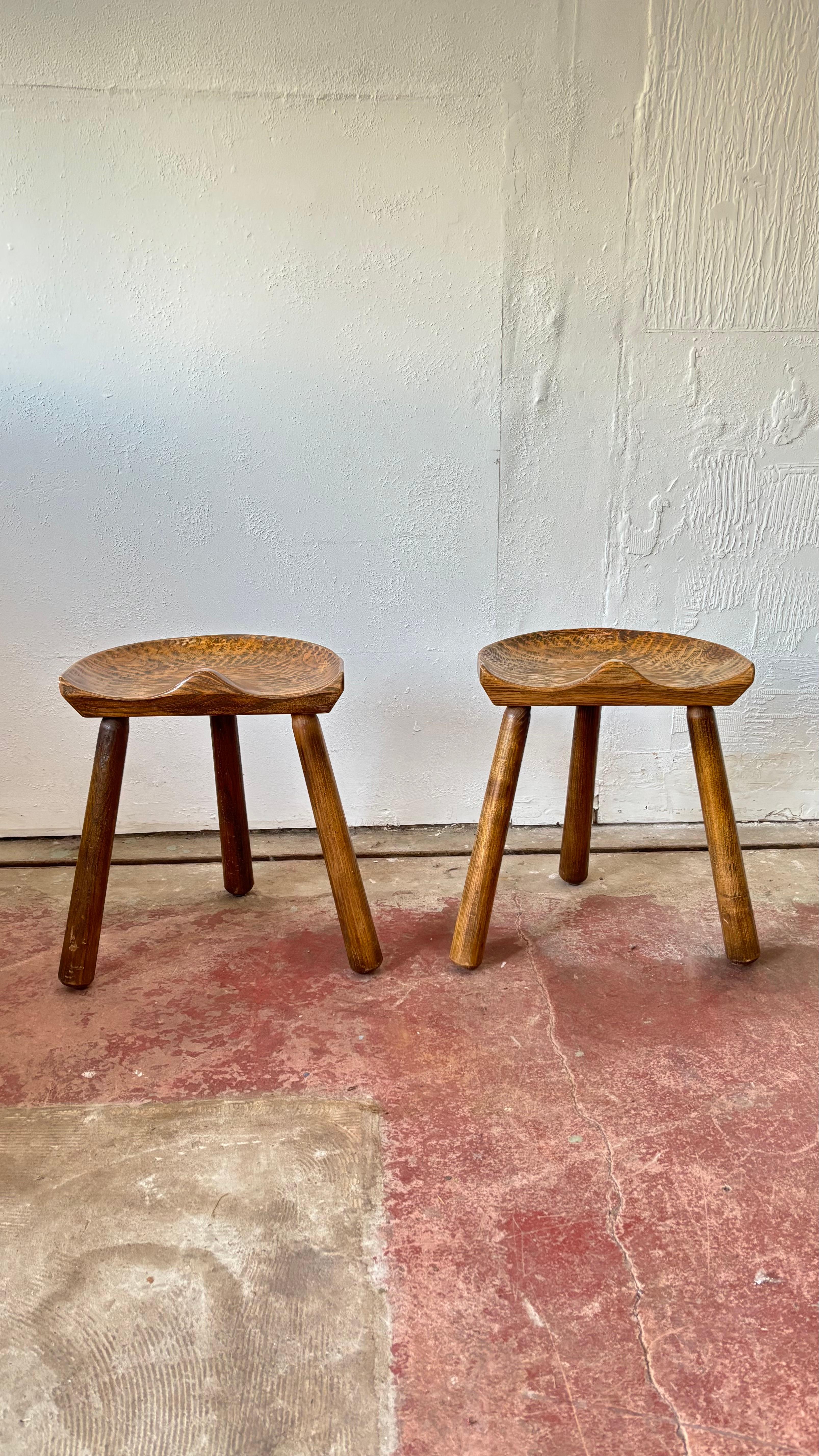 'Le Selou' is an Artisanal seat, made in Millavoise in the Aveyron, France.  Derived from the three-legged milking stool with the seat in the shape of an old tractor seat.  Brutalist style in solid chestnut, faceted feet, engraved 