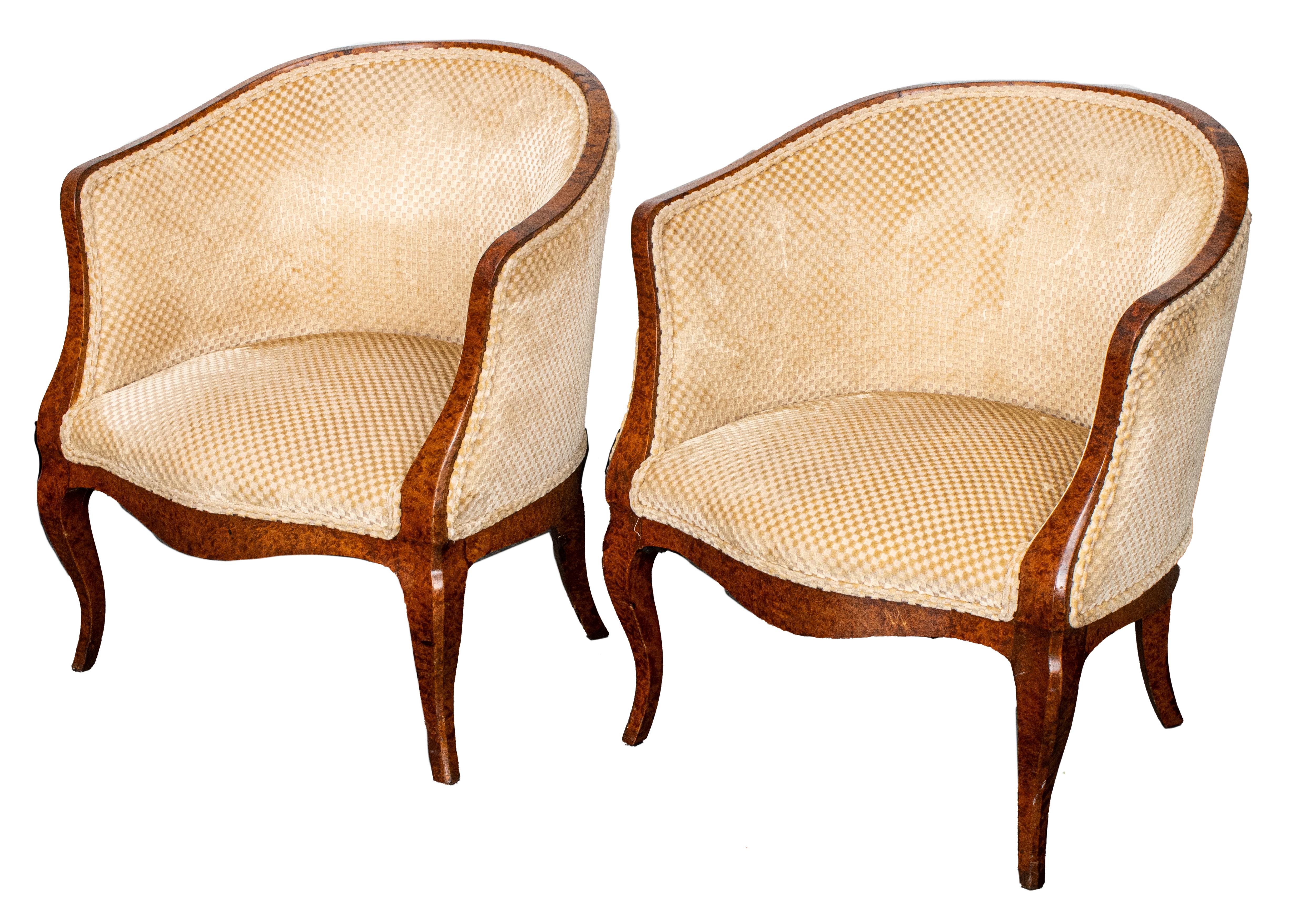 French antique pair of upholstered lounge chairs in burl wood veneer, with barrel backs, on cabriole legs. Measures: 30