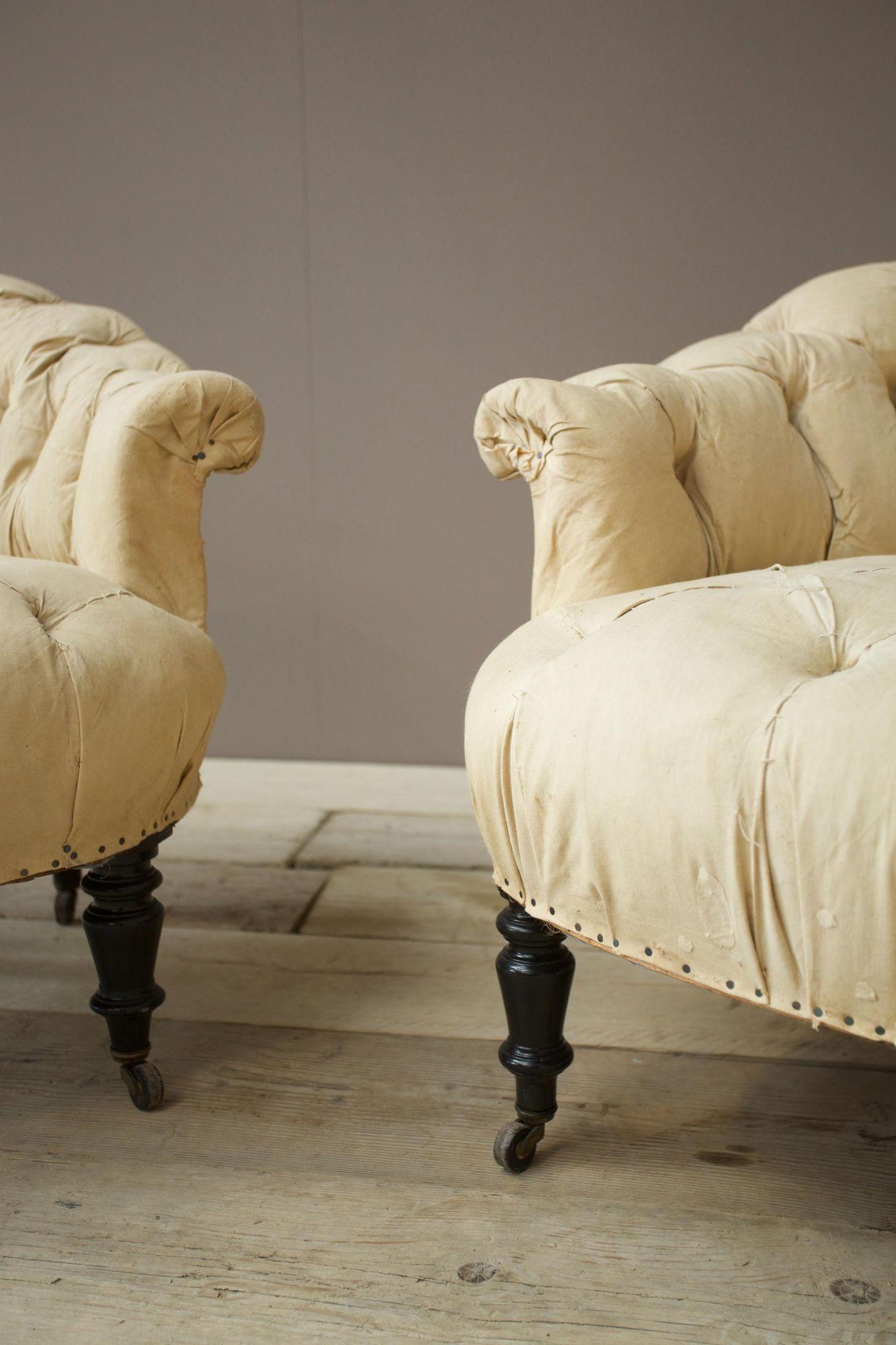These are a very nice quality pair of French buttoned tub chairs. Attractive size with good seat height and lower than average back. The deep buttoned detail once upholstered will give these a very sumptuous appearance. Comfy and well designed. 
