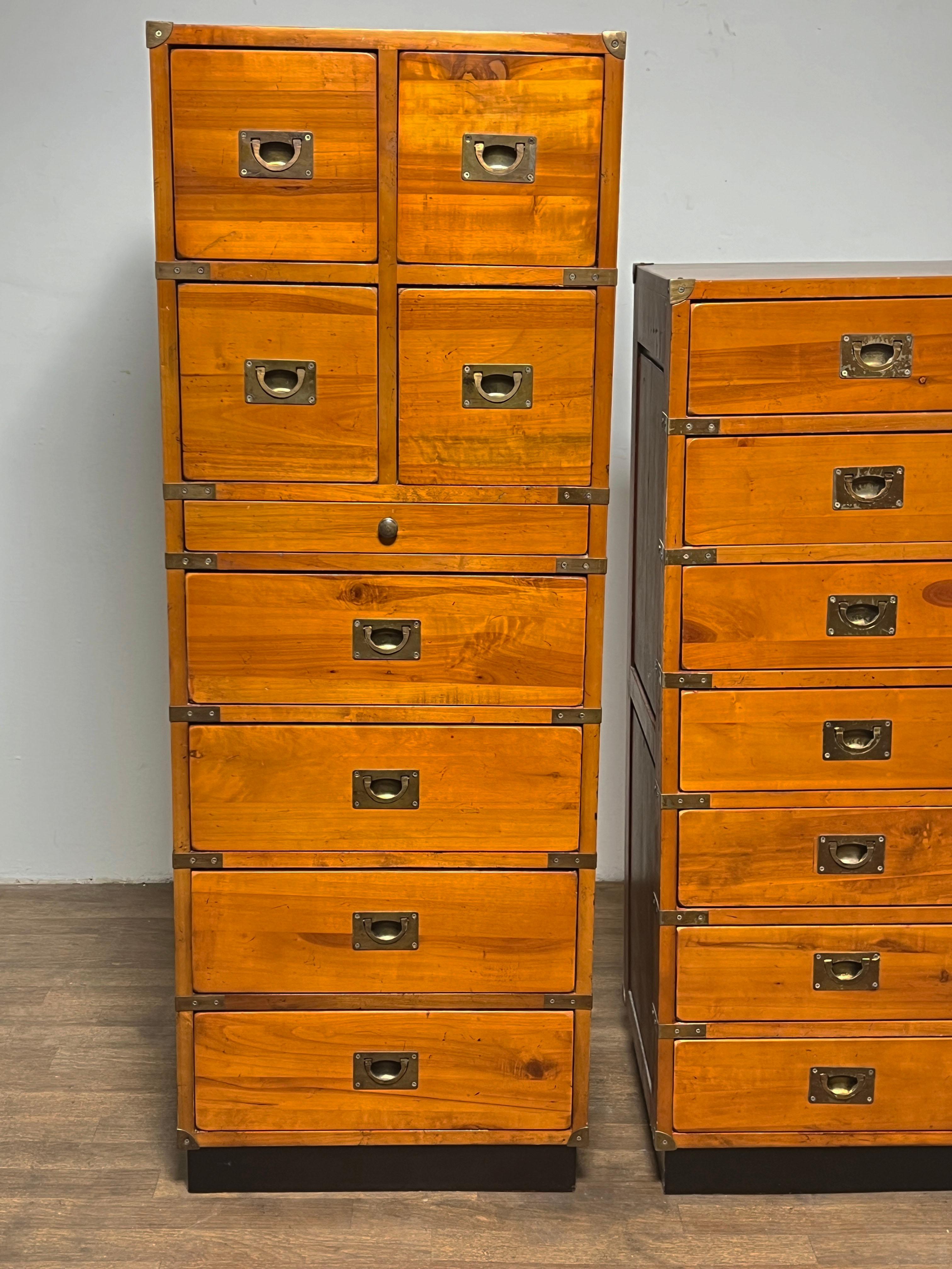 A pair of vintage campaign (cabinet de voyages) chests in amber toned solid pine with brass hardware, made in France, ca. 1970s.  The taller chest measures 54 3/8