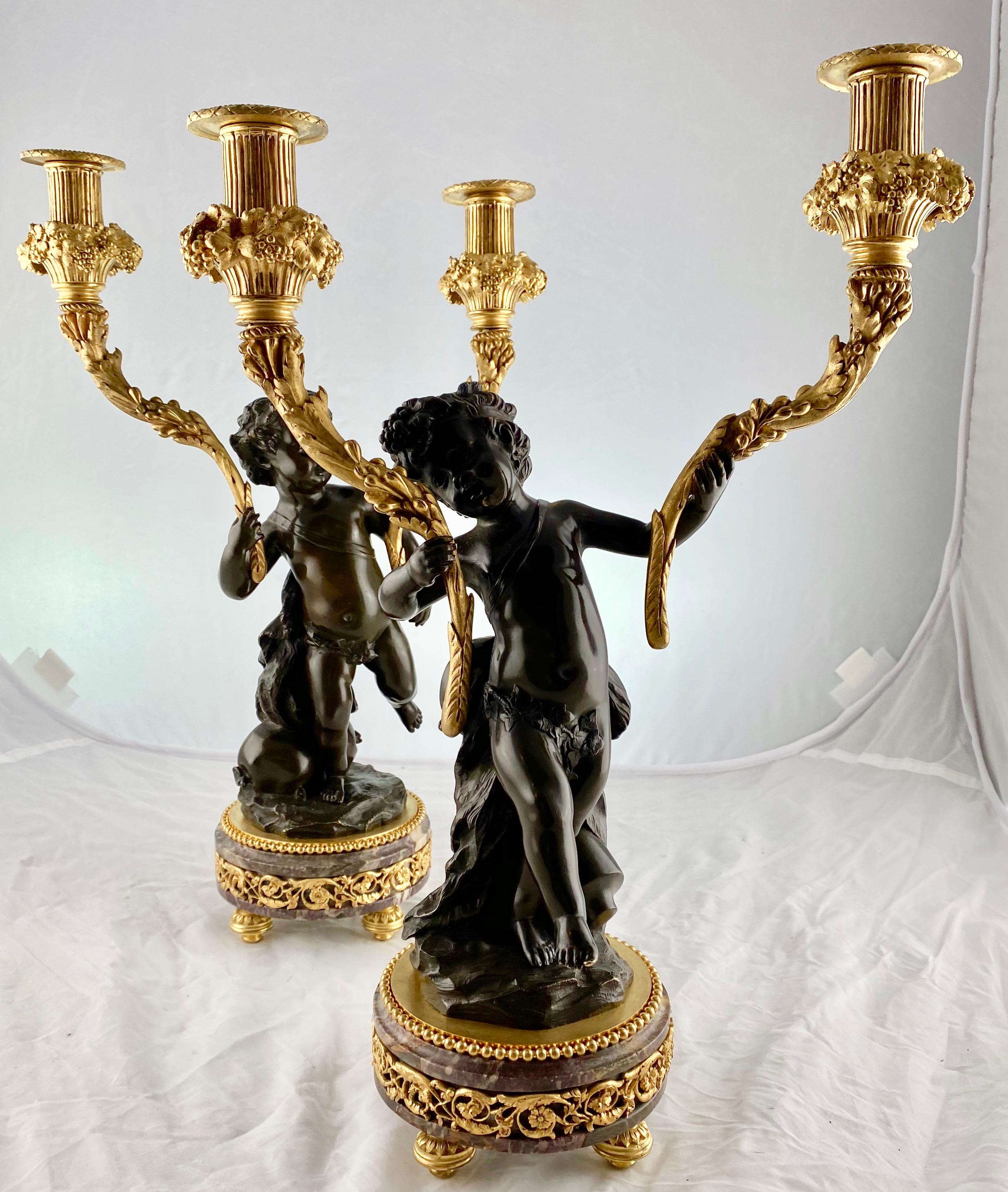 A pair of happy candelabra, French from the late 18th. The candelabra are depicting putti dancing around, one standing on a sack of wine the other with a wine amphora and a musical instrument on his back.
Dark patinated and gilt bronze with bases