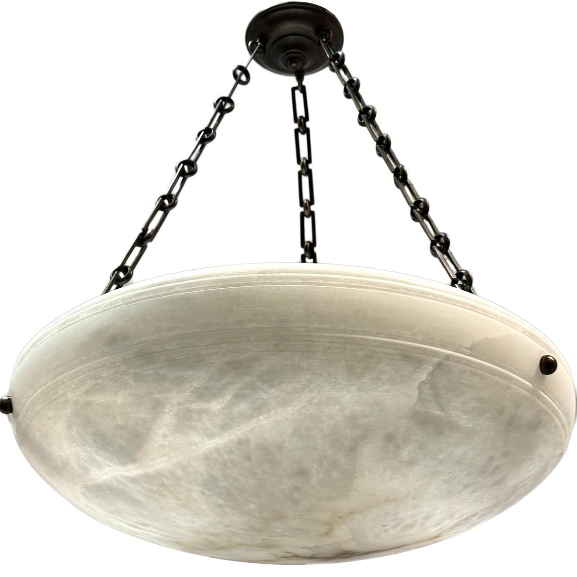 Set of six circa 1950's French carved alabaster light fixtures with 3 Edison interior lights and patinated bronze chain and canopy.  Sold & priced individually.

Measurements:
Diameter: 23
