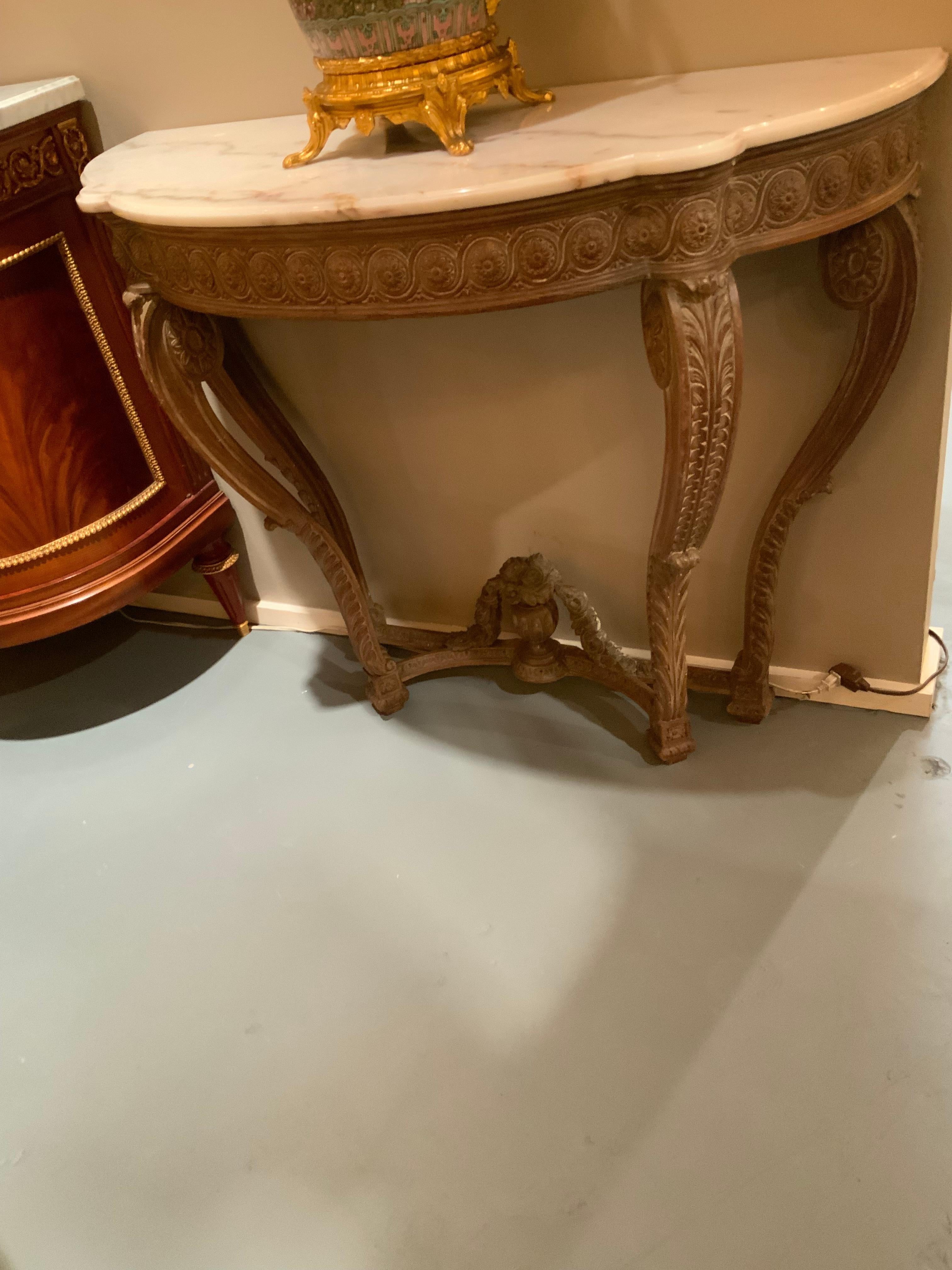 Carved Pair of French carved Demi lune shaped console tables with white marble tops For Sale