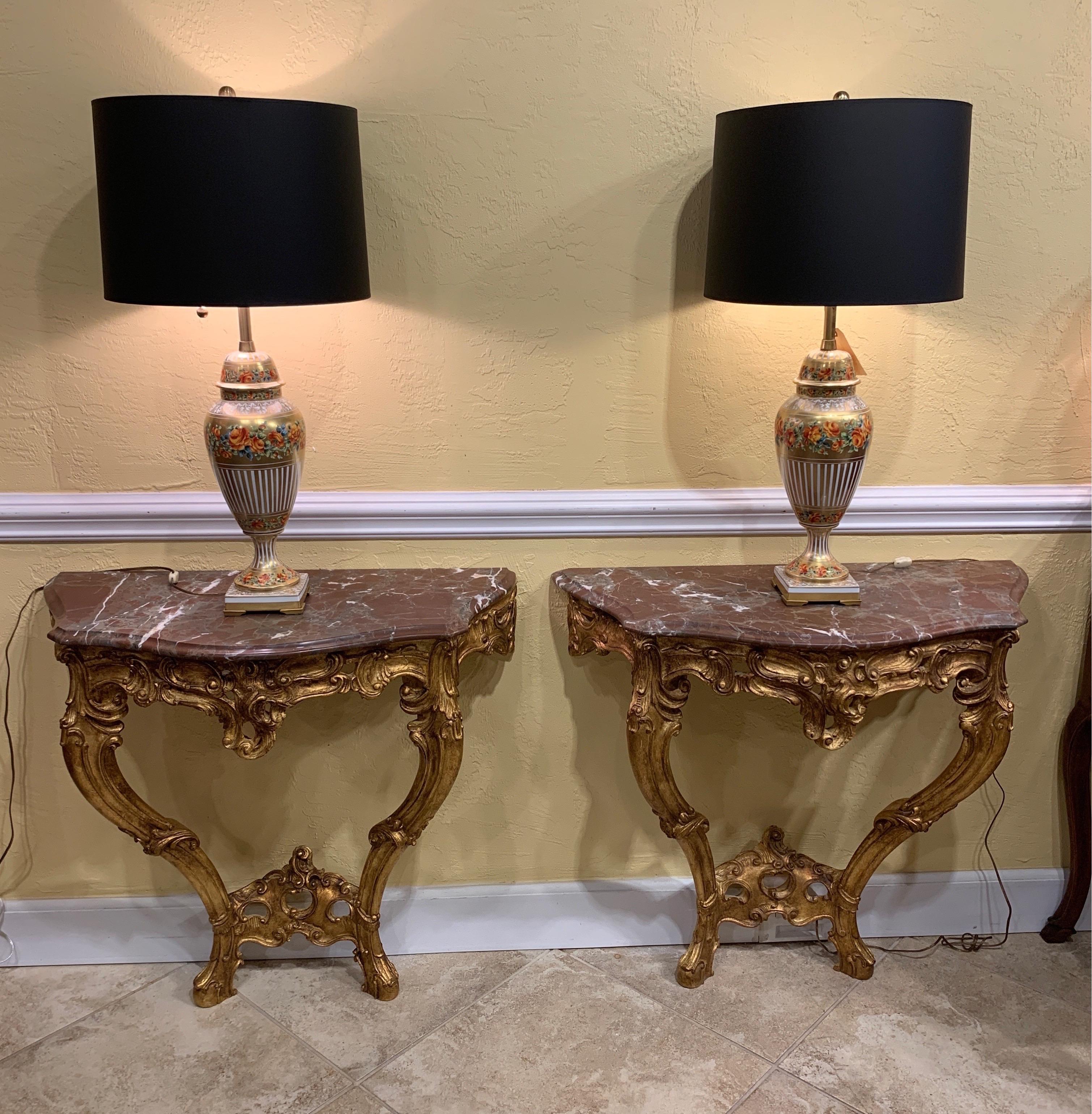 Pair of French marble top consoles. Rococo style. Beautiful figural marble. Thumb molded edge. Carved and giltwood, circa 1950s.