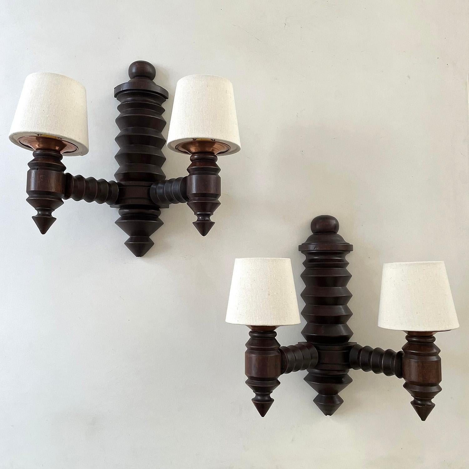 Pair of French carved oak wall sconces in the style of Dudouyt
France, circa 1940’s
Handmade, intricately carved design
Newly reconditioned
Patina to wood from age 
Perfectly imperfect
Newly rewired
New linen shades 
Sold as a pair
Single socket