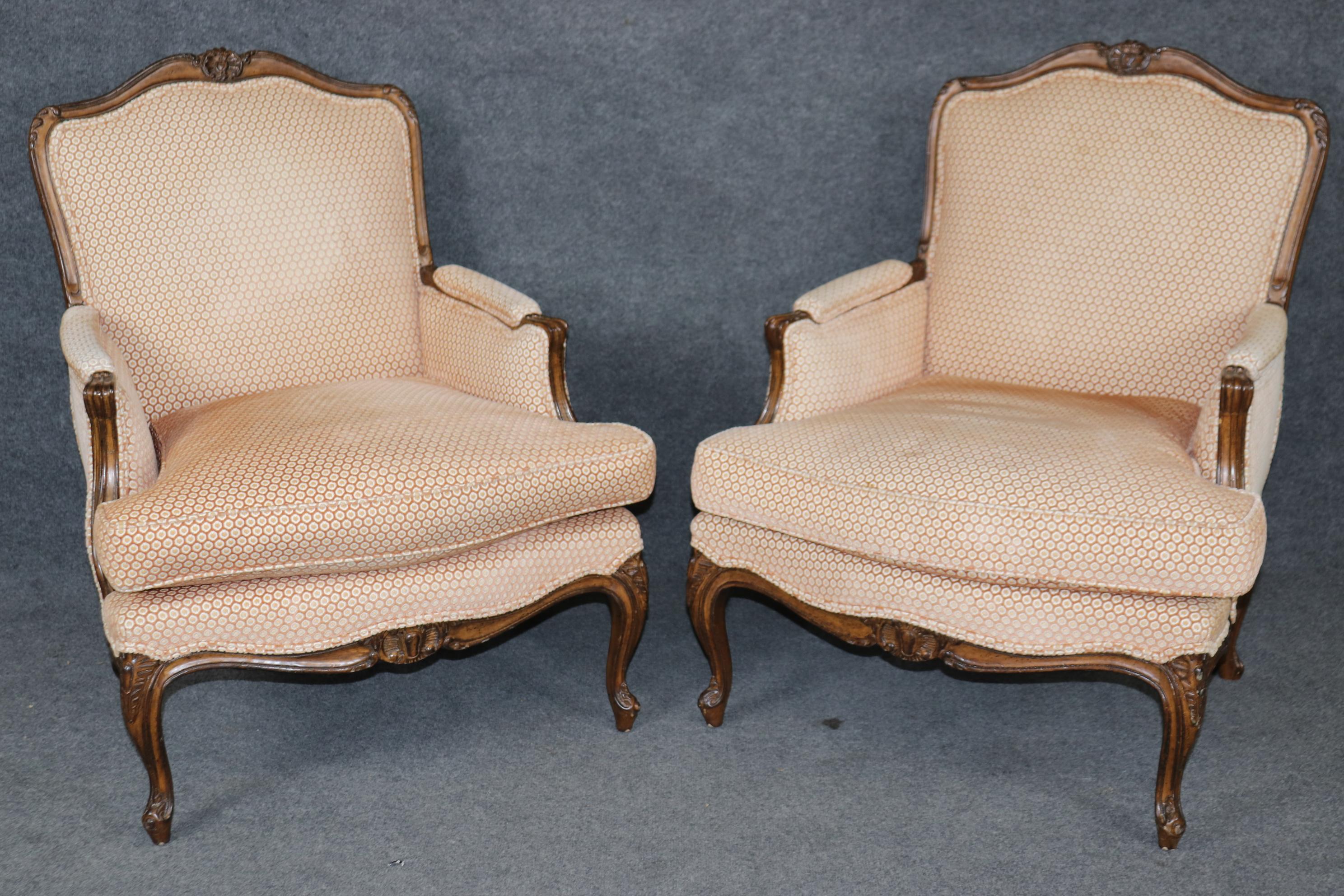 This is a gorgeous pair of French Louis XV style bergere chairs with beautiful carving and beautifully vintage upholstery. The frames are in good condition and the upholstery is in good condition but as they are vintage chairs with vintage