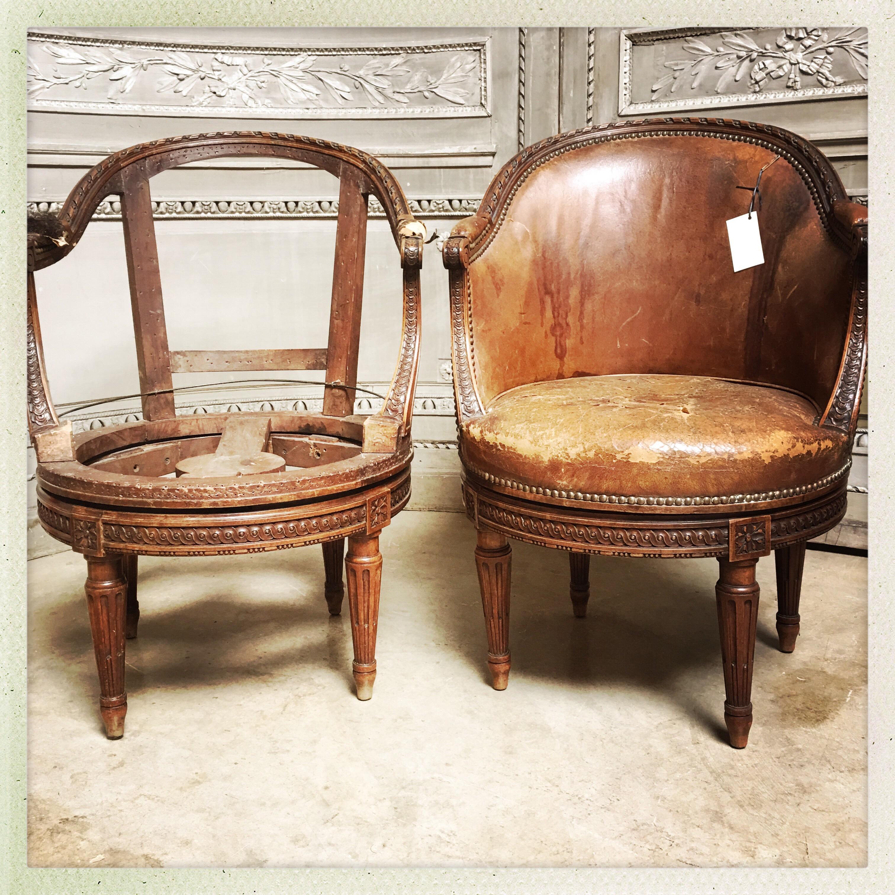 A rare pair of French carved walnut Louis XVI style swivel desk chairs, sold for the frames only.