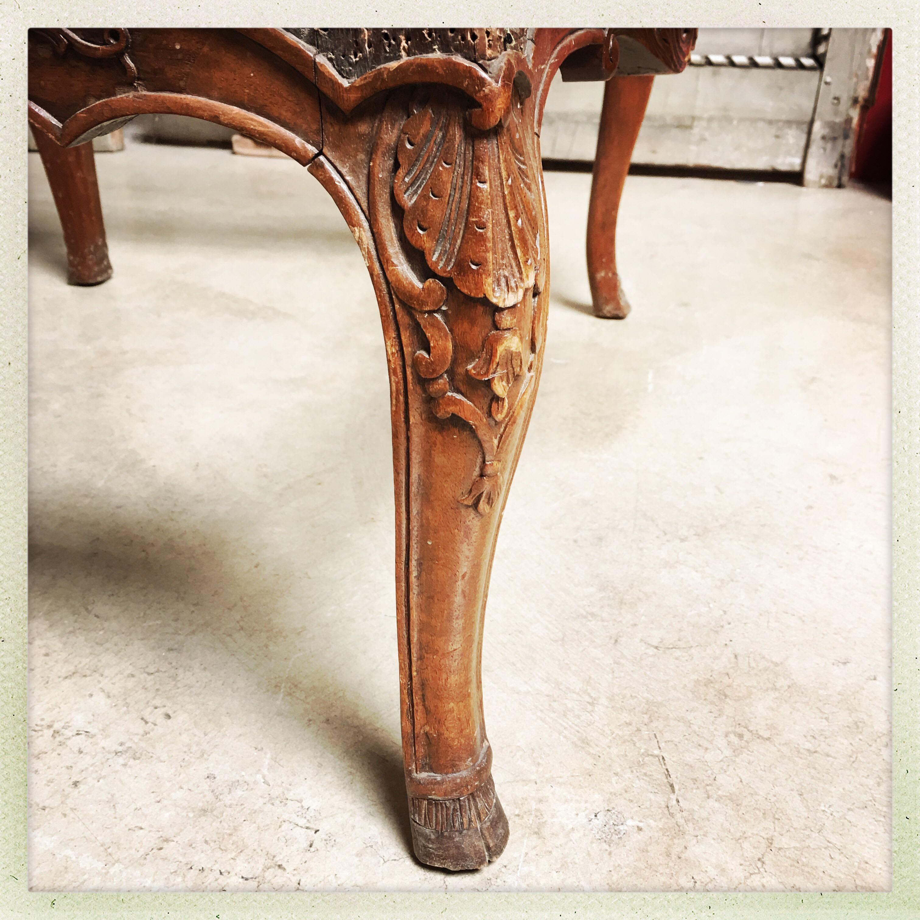 A beautifully carved pair of French Regence style armchair frames in walnut from the 19th century.