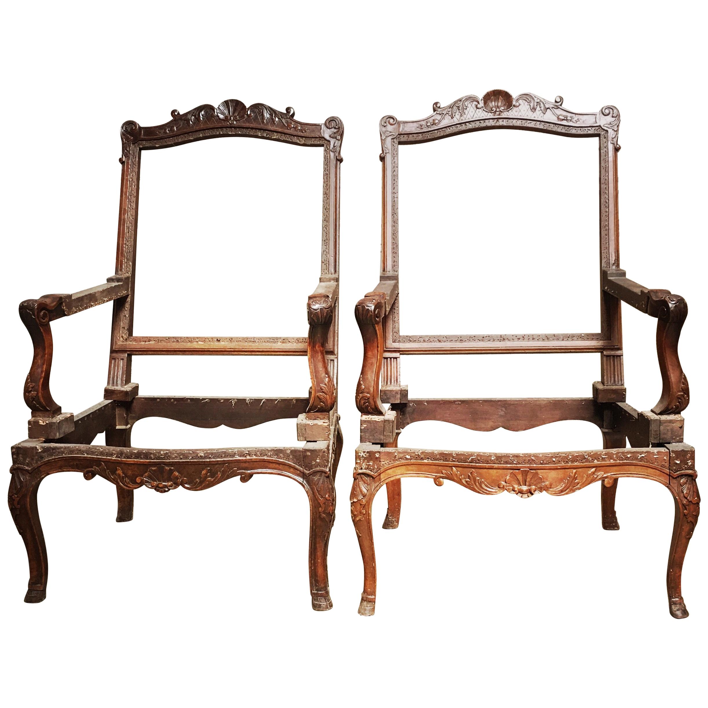 Pair of French Carved Walnut Regence Style Fauteuils For Sale