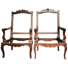 Pair of French Carved Walnut Regence Style Fauteuils