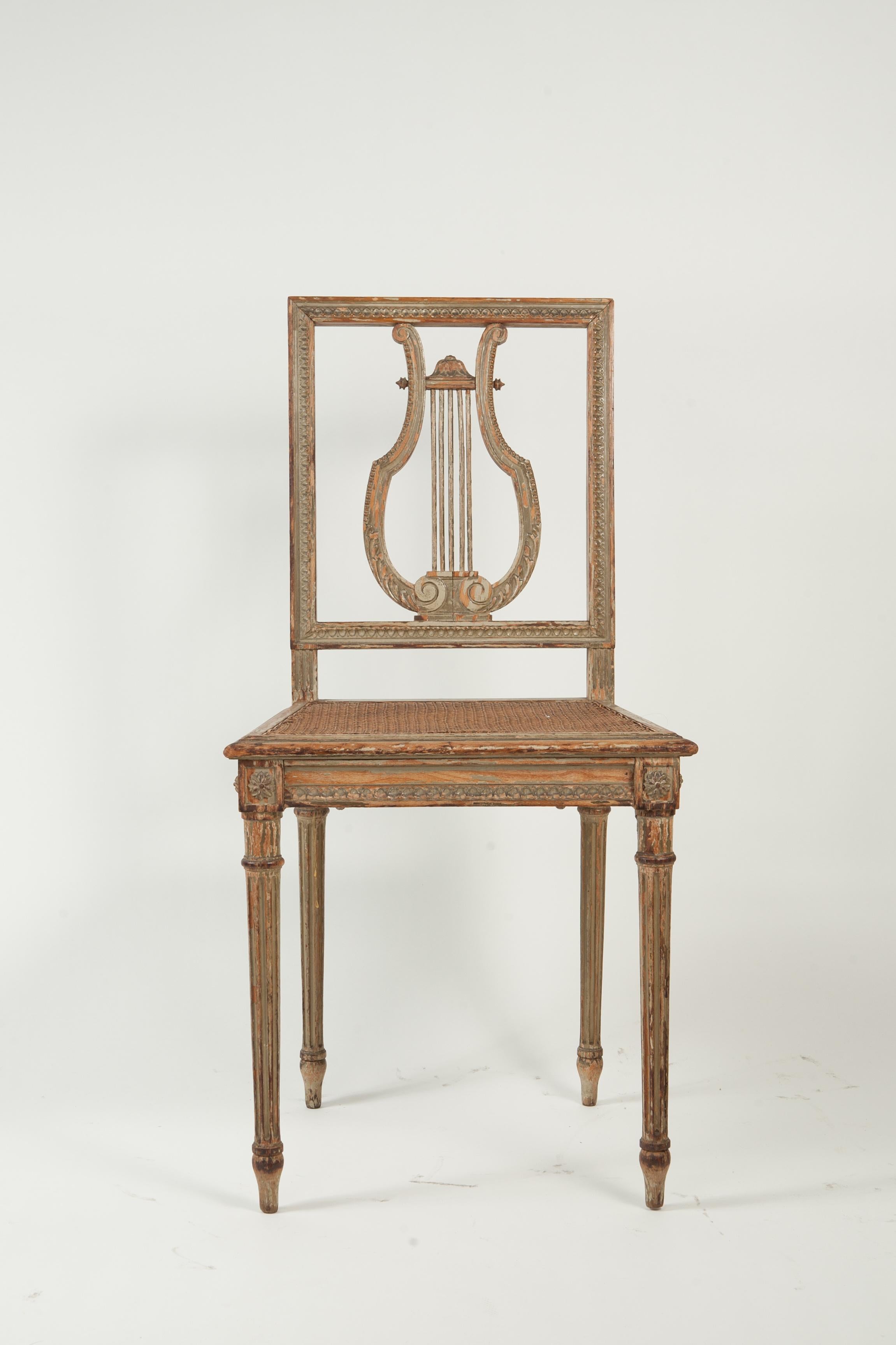 Pair of green painted, lyre back, side chairs with hand caned seats. Beautiful patination throughout to these 19th Century chairs.