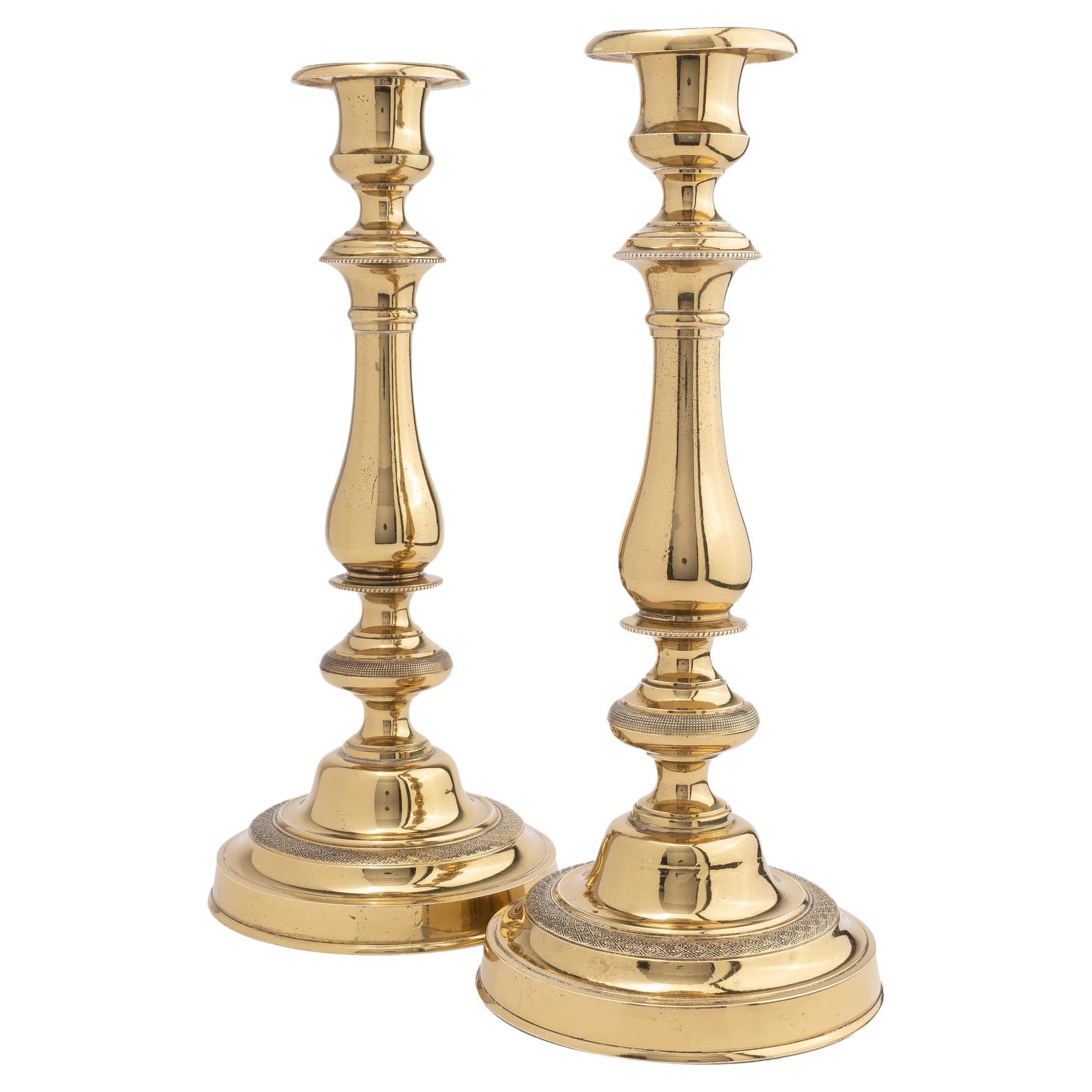 Pair of French cast brass candlesticks, 1800-10 For Sale