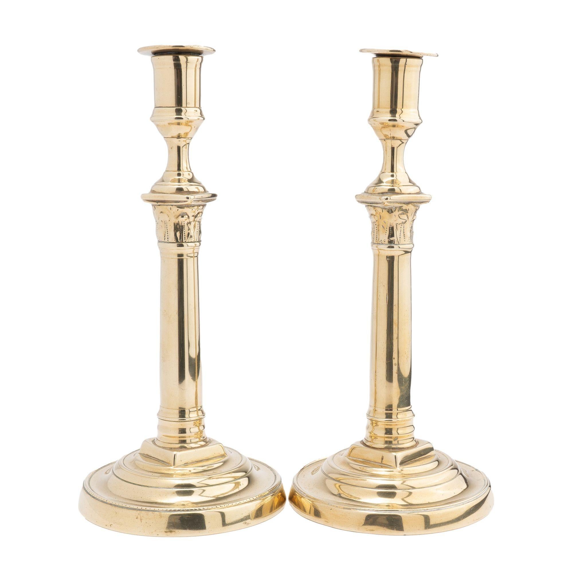 Pair of cast brass columnar candlesticks with Corinthian capitals supporting urn form candle cups. Seam construction with threaded attachment of the candle shaft to the base.
France, circa 1820.
Condition: Good original condition. Surfaces have