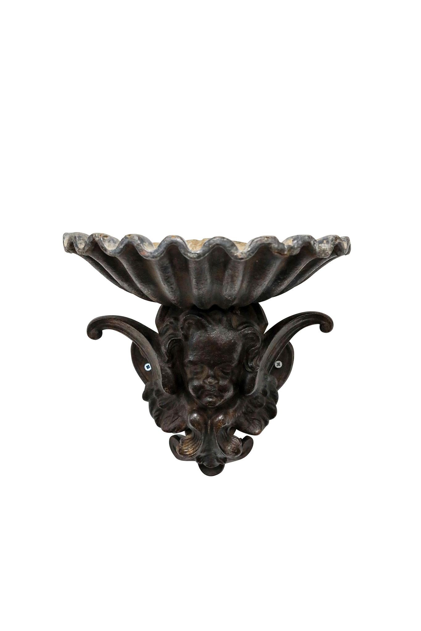 Pair of French Cast Iron Angel Head Vessels. Wonderful casting. Great as planters. Circa 1890.

11