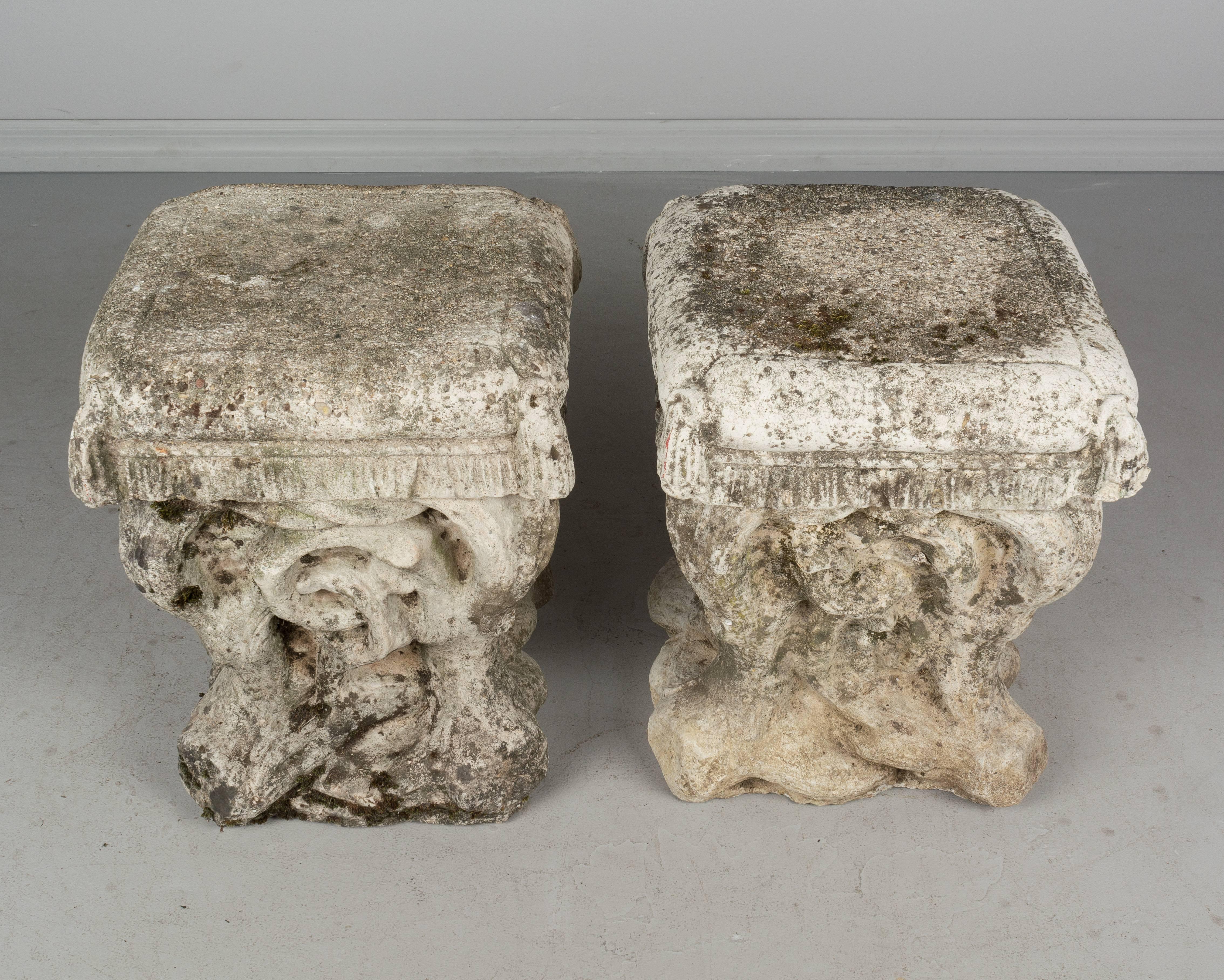 A pair of French cast stone garden stools. Organic forms of twisted vines topped with fringed and tasselled seat cushions. Old mossy patina. About 100 Lbs each. Most garden sculptures are stored outside where it continues to acquire additional
