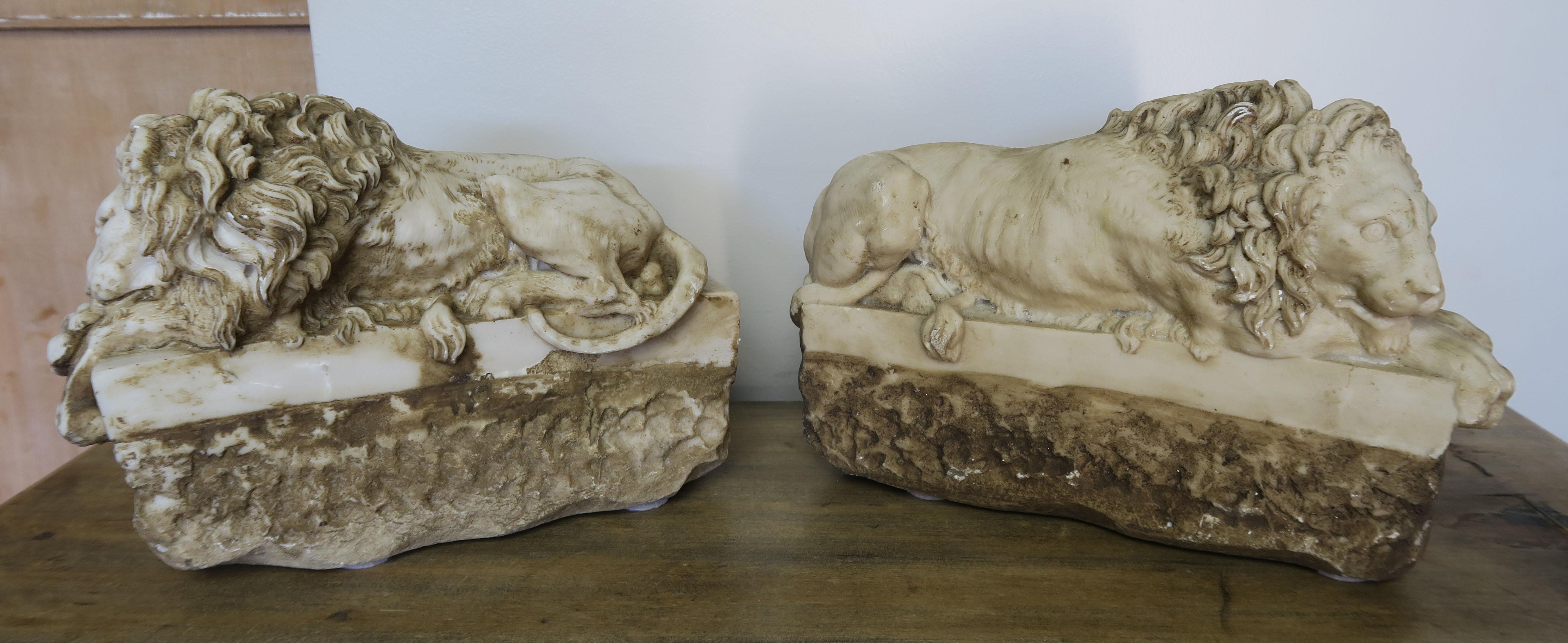 Pair of French cast stone lions. The intricate details can be seen throughout. They would be great mounted into custom lamps or to use as decor on a table or bookshelf.