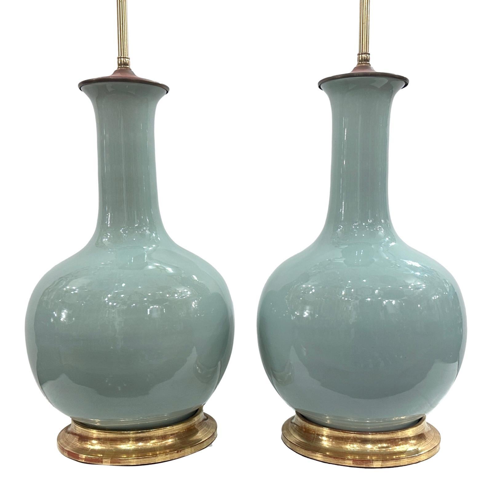 Pair of circa 1960's French celadon porcelain lamps with gilt bases.

Measurements:
Height of body: 19