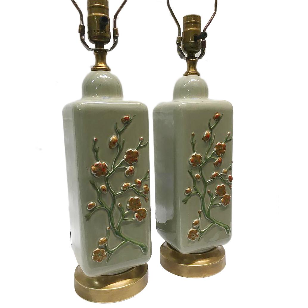 Pair of circa 1940s celadon lamps with gilt and painted foliage and flower in relief.

Measurements:
Height of body: 15?
Widest point: 4.5?.