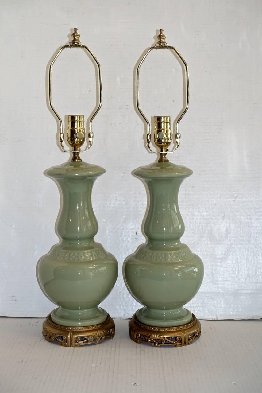 A pair of French circa 1930s celadon table lamps with cast bronze bases.

Measurements:
Height of body: 14.5