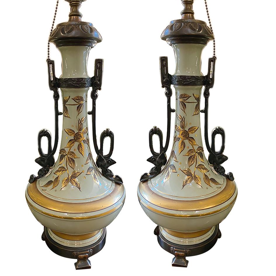 A pair of French circa 1940's celadon table lamps with hand-painted gilt decoration and bronze fittings.

Measurements:
Height of body: 18
