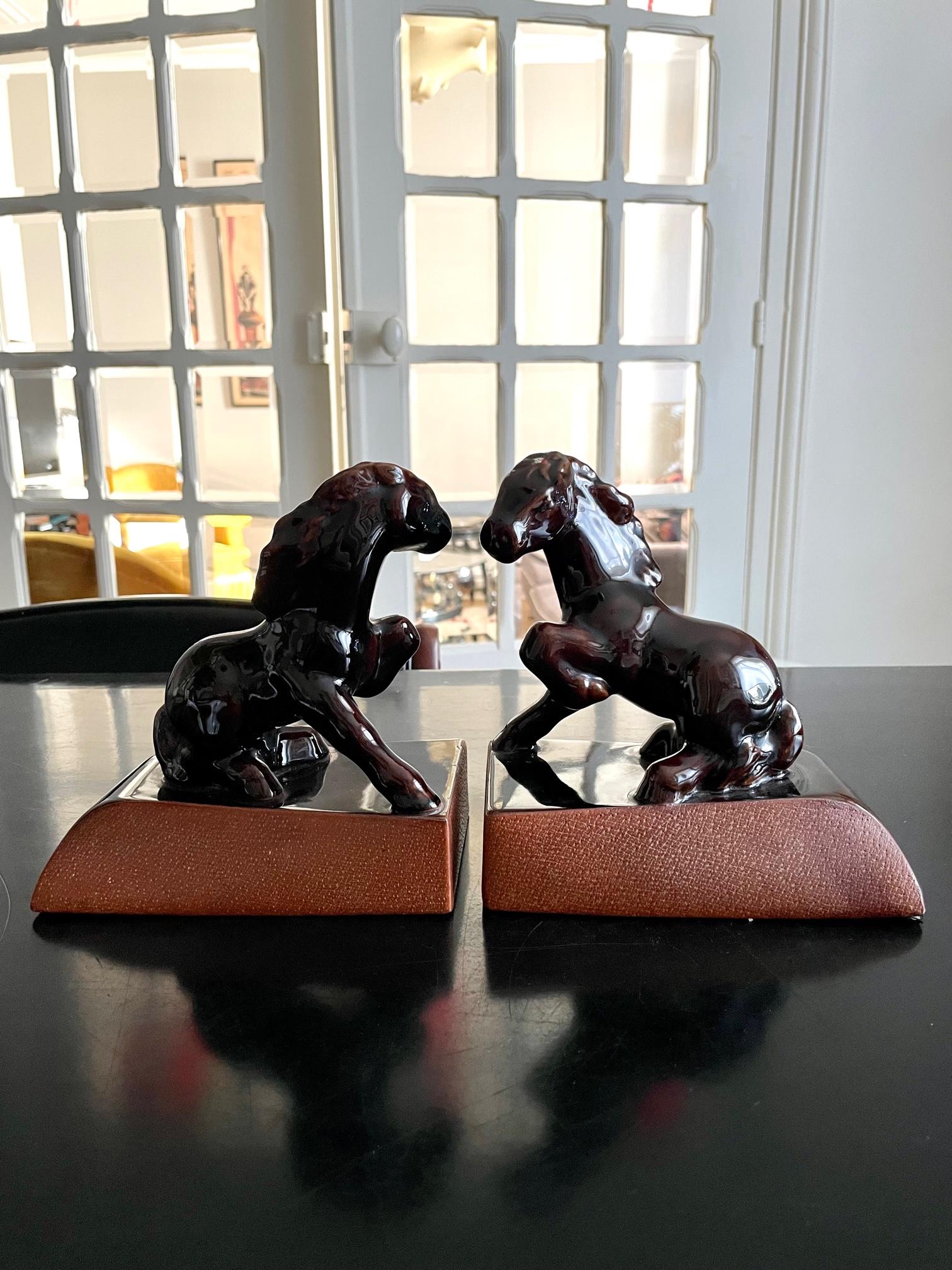 Pair of book ends in glazed ceramic with leather base, circa 1950's.