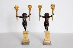 Pair of French Charles X Patinated Bronze and Gilt Figurative Candelabras
