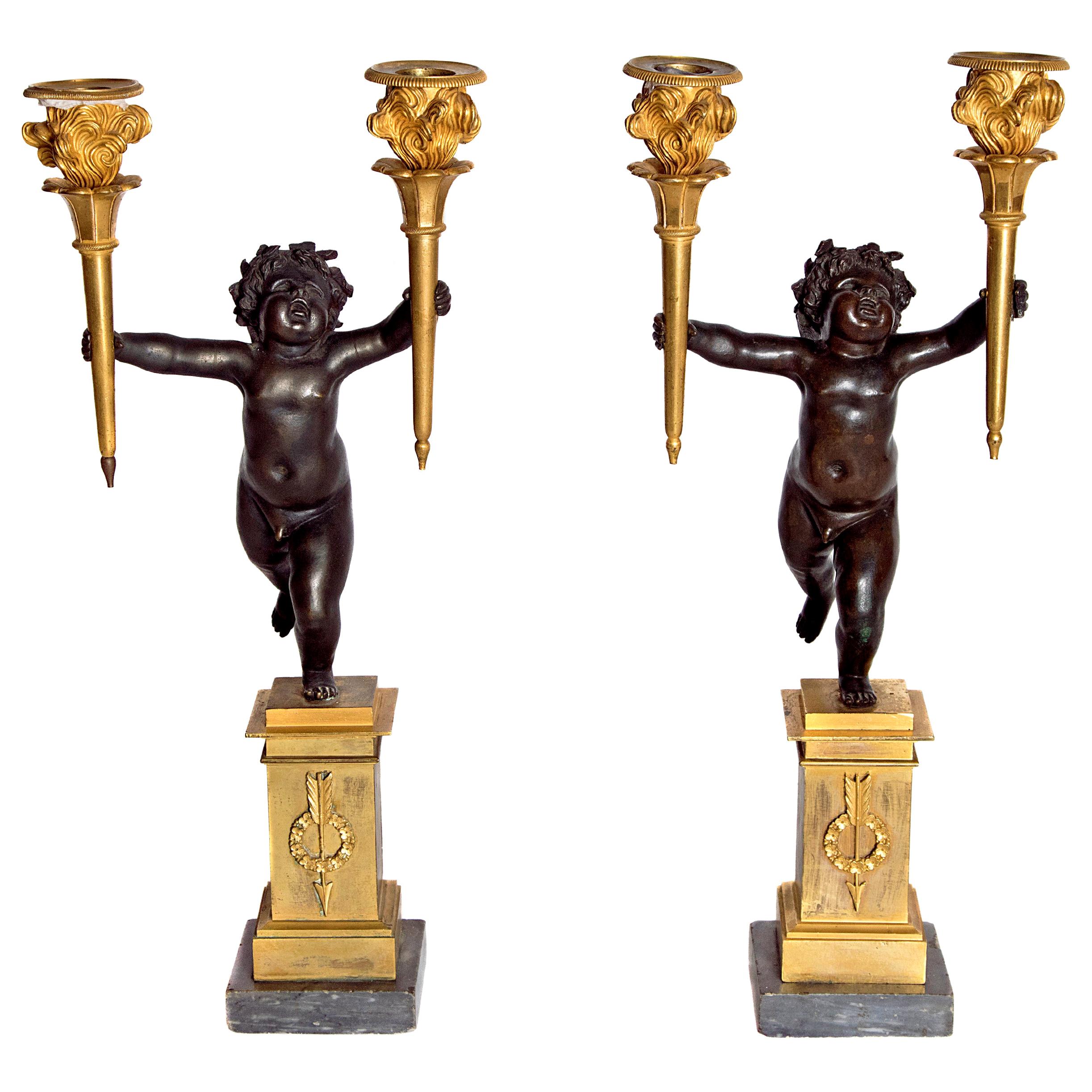Pair of French Charles X Patinated Bronze and Gilt Figurative Candelabras For Sale