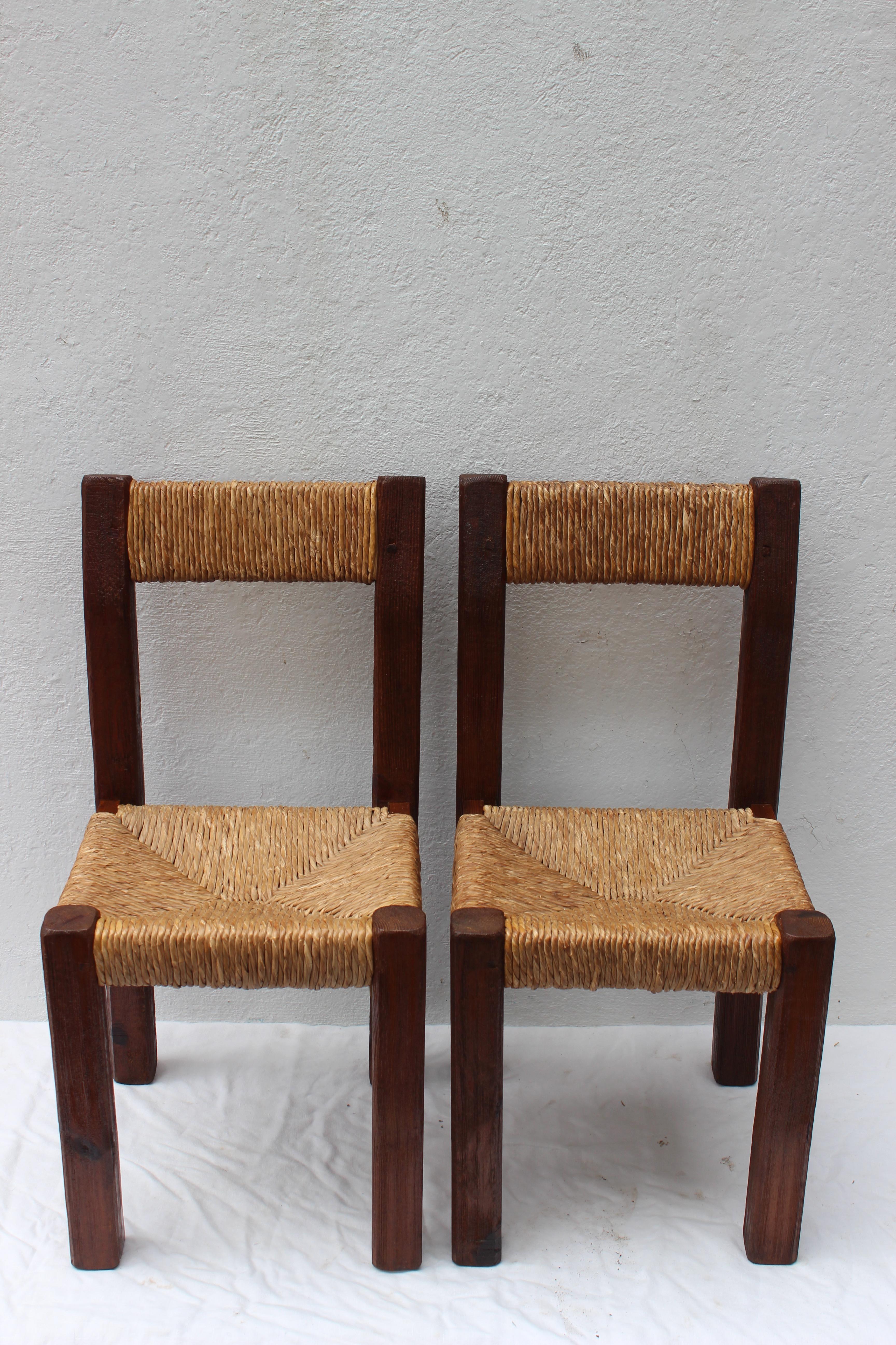 Pair of French rustic wood side chairs with rush seats in the style of Charlotte Perriand.