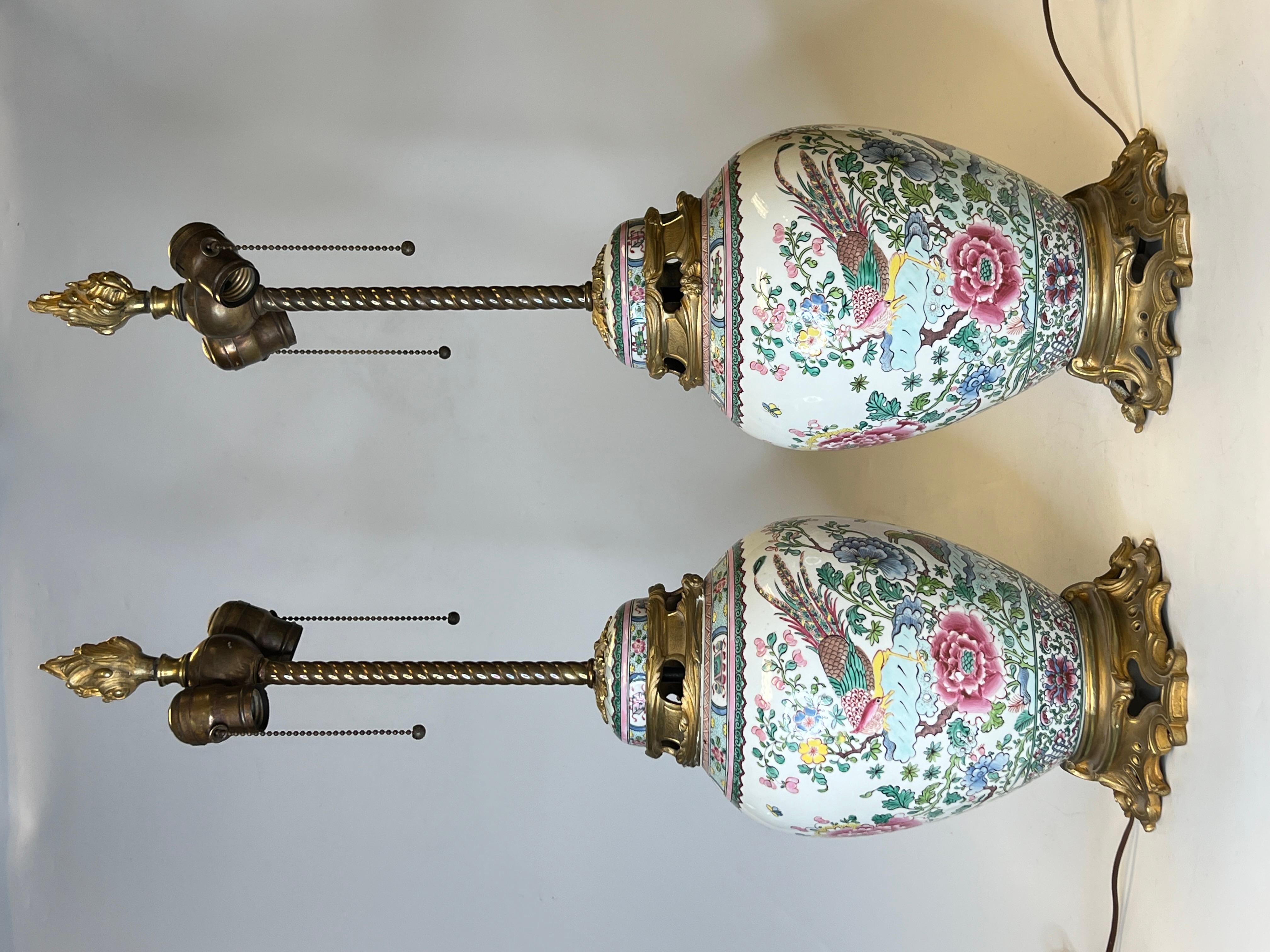 Pair of 19th century French Chinese export style porcelain and gilt bronze table lamps with Phoenix bird and flower motifs.