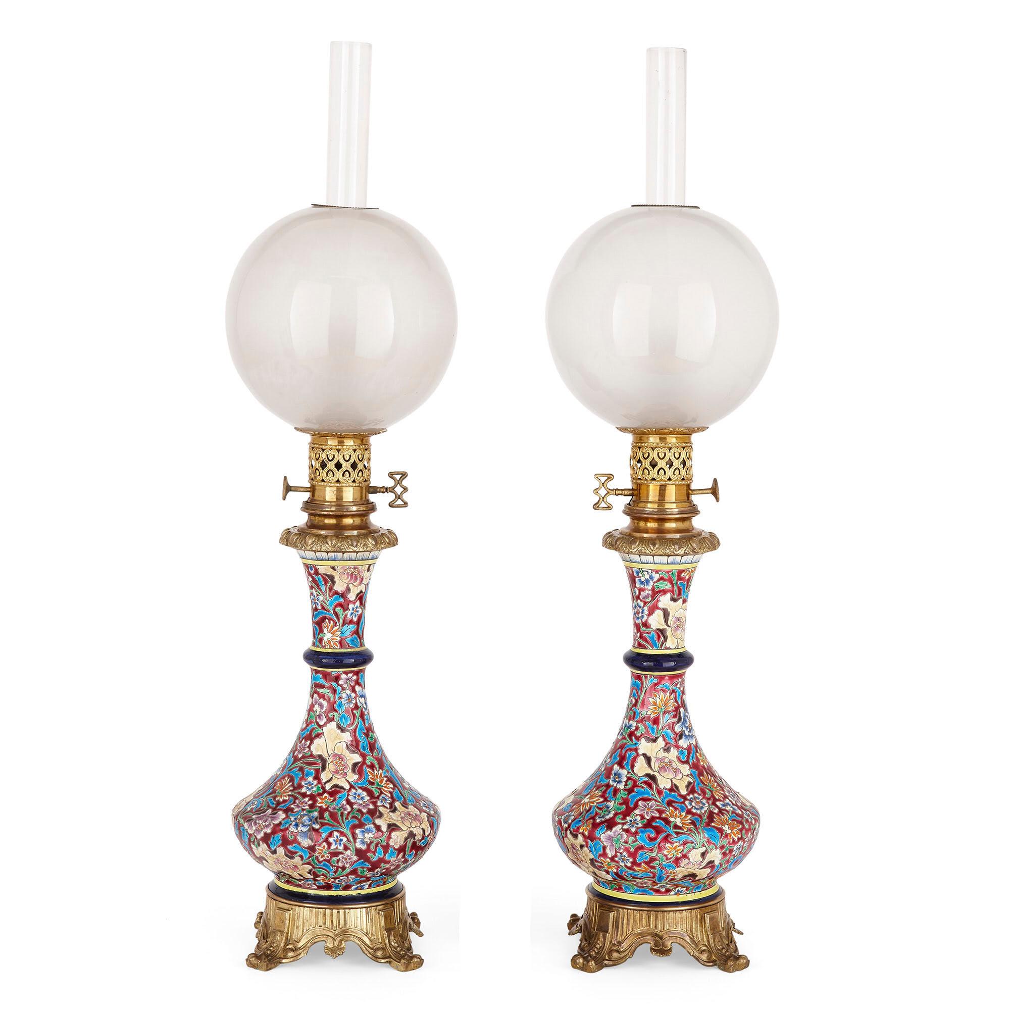 Pair of French Chinoiserie style faience, glass, and gilt bronze lamps
French, late 19th century
Measures: Height 75cm, diameter 18cm

Each lamp in this pair is wrought from exquisite faience (attributed to Longwy), gilt bronze, and fine crystal