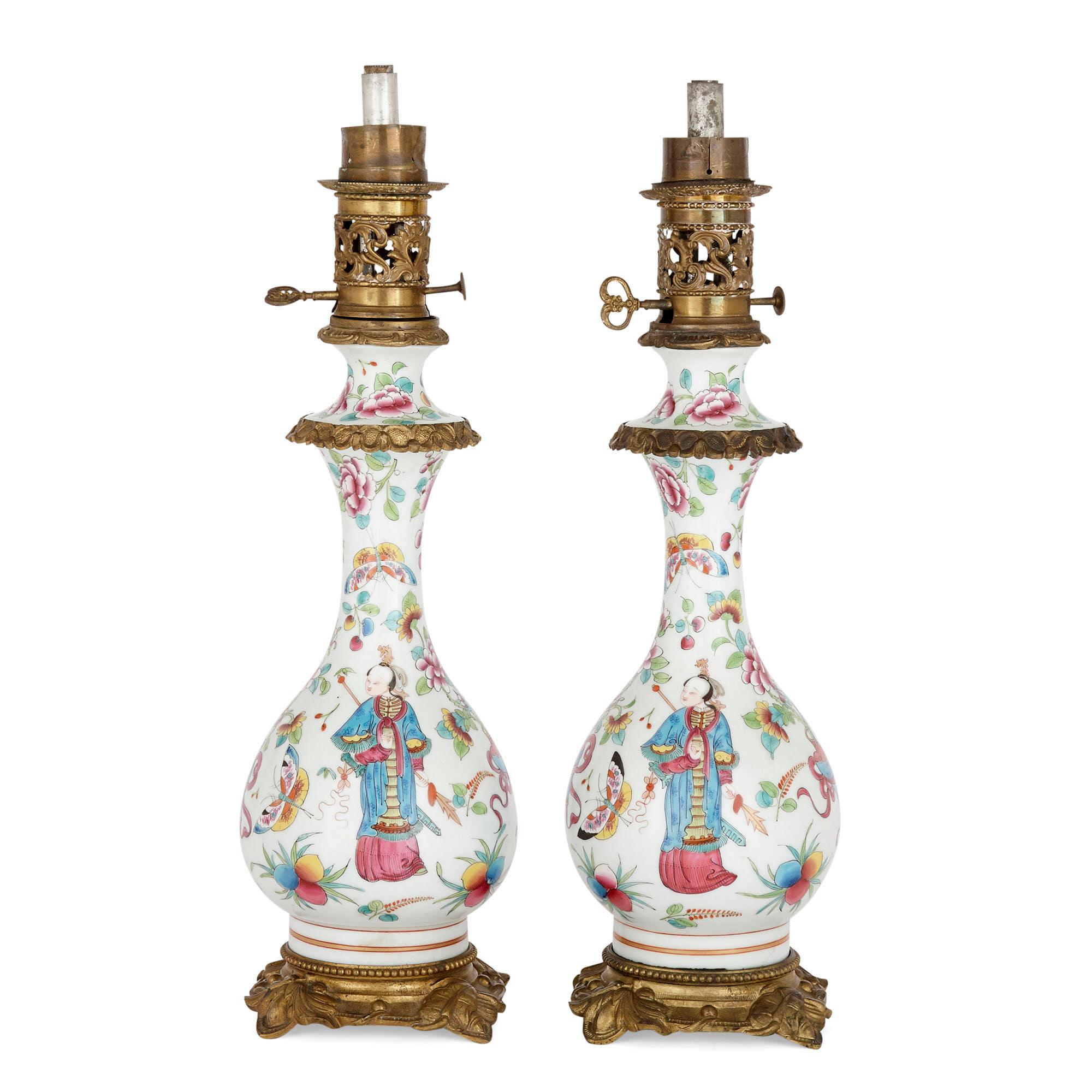 Each oil lamp in this pair is wrought from gilt bronze and Bayeux porcelain and is designed in the chinoiserie style so prominent in French art during the latter 19th century. Each lamp stands on a gilt bronze base, raised by four foliate feet, and
