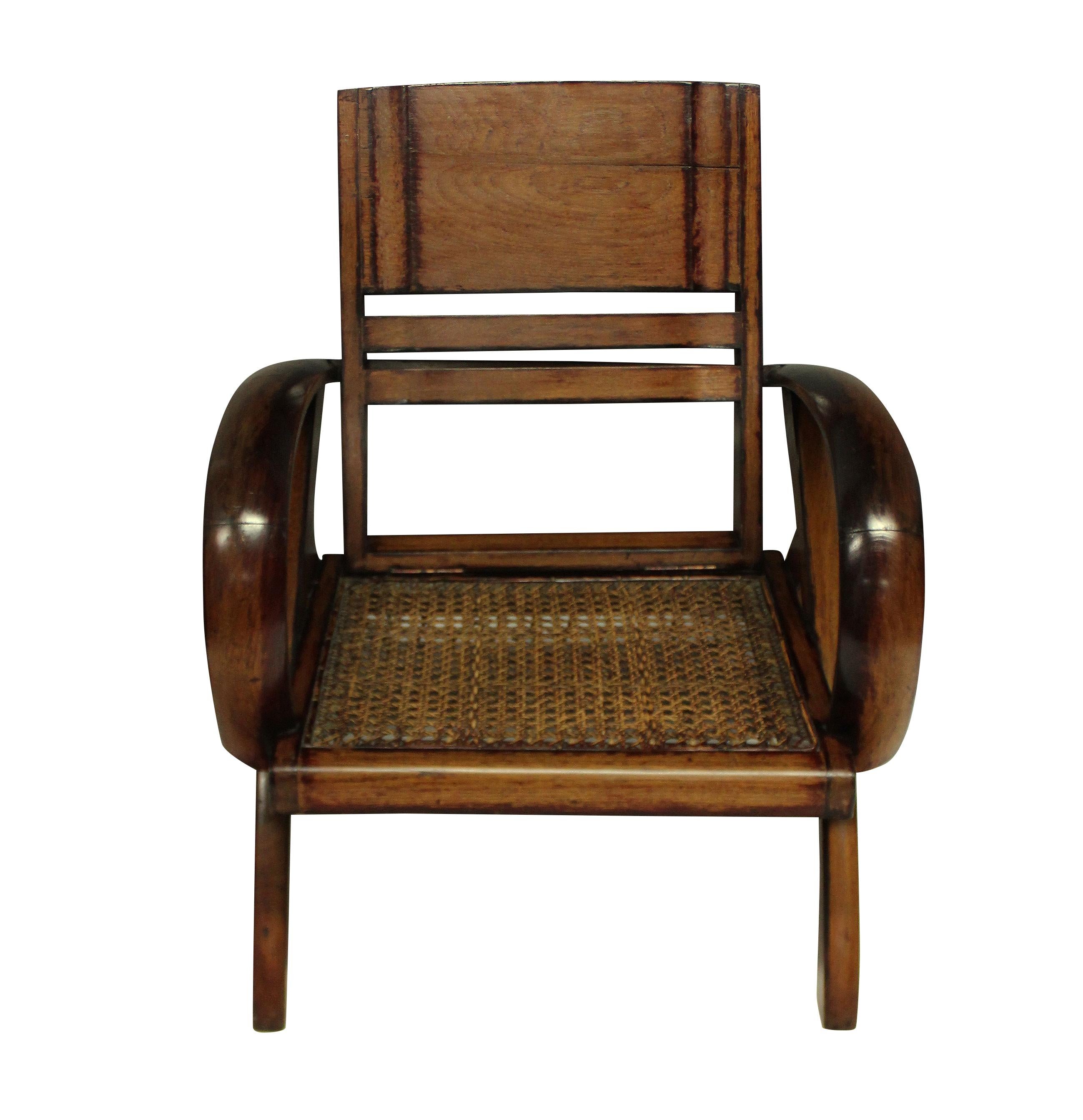 A pair of French Colonial Art Deco planter chairs, in stained teak, with cane seats. Vietnam.