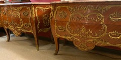 Pair of French Commodes bombe' form with elaborate bronze mounts