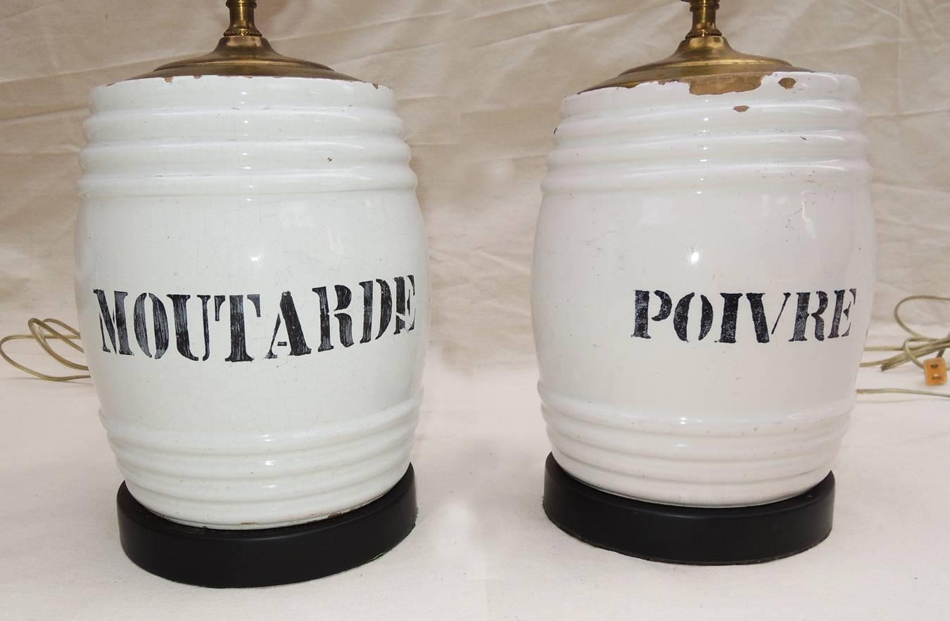 Lovely pair of ceramic mustard jar lamps. Large jars probably from a store made into lamps in the 1960s.
Pure white with strong black graphics. Charmant! Measure: Base height 12 in.