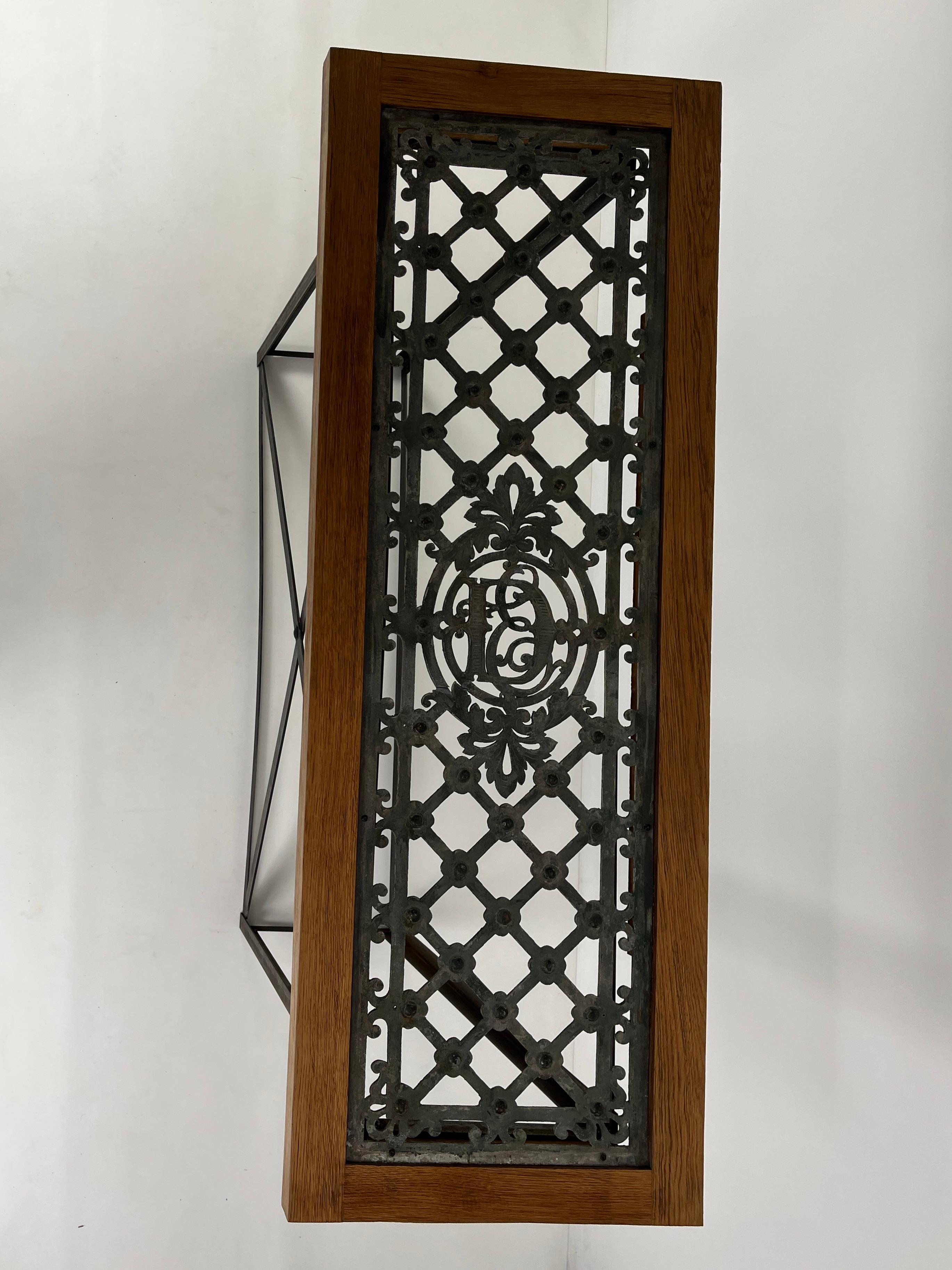 Console Tables with Decorative Parisian Door Panel 
Where history meets modern artistry.
This stunning pair of console tables transforms a salvaged Parisian entry door panel into an exquisite glass-topped statement piece. The panel's intricate
