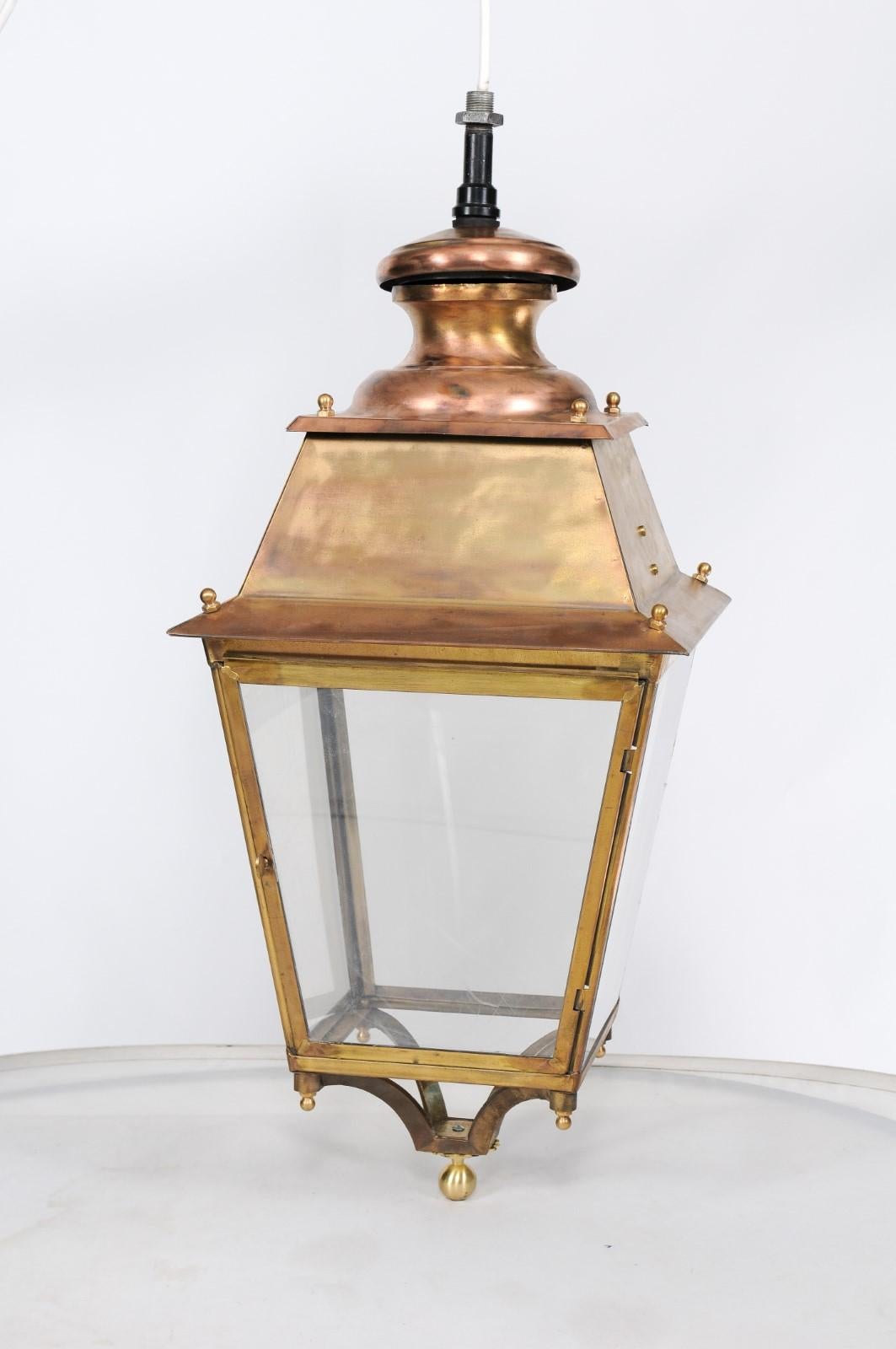 A pair of French brass, copper and plexiglass lanterns from the early 20th century, with single door and discreet finials. We’re always on the lookout for gorgeous French lanterns, like the kind you see hanging in charming villages, so when we