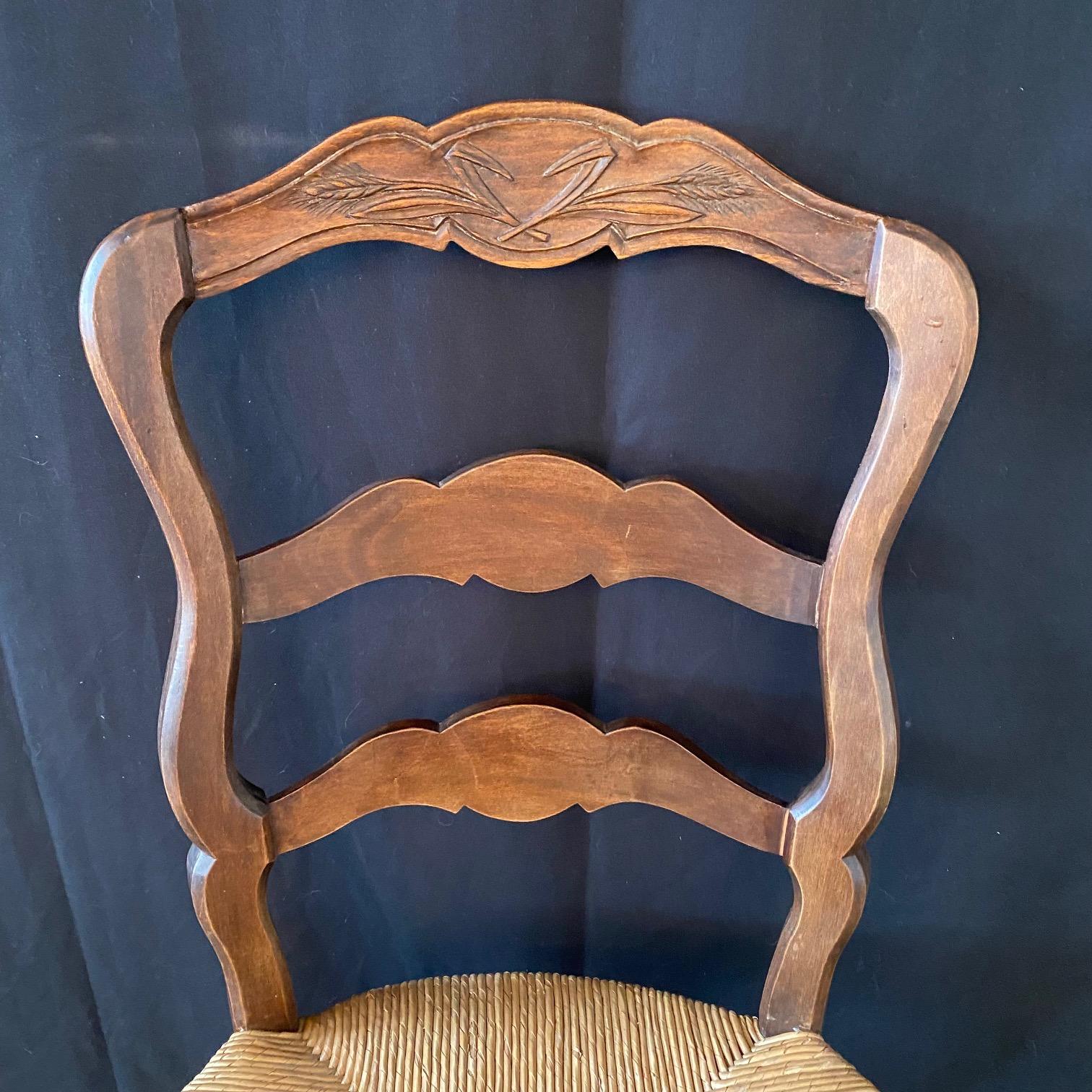 Early 20th Century Pair of French Country Hand Woven Rush Seat Dining Chairs with Lovely Carvings