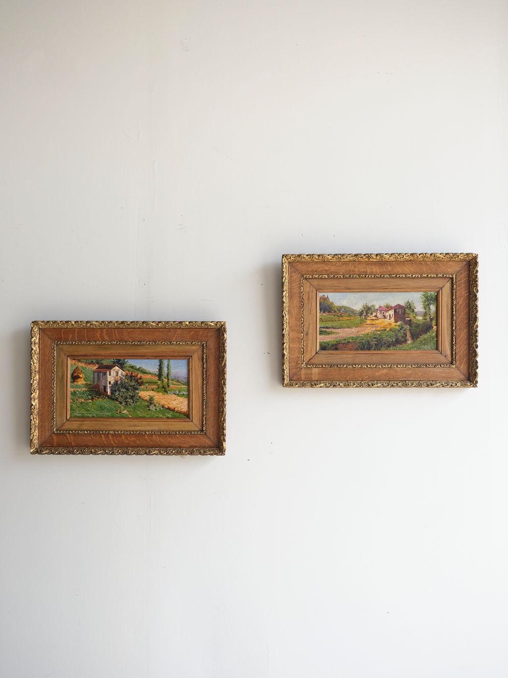 This pair of early 20th century oil paintings by Alfred Blondear are truly stunning. They feature the English countryside landscape. The homes/farms are a tan/cream color with red roofing. These oil paintings are in their original frames. They are