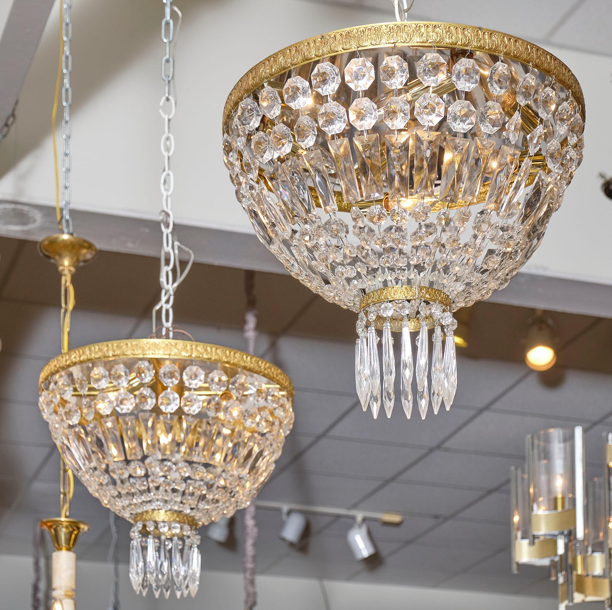 Pair of French crystal chandelier flush mounts made of embossed gilt brass and crystal. The pair features a rich array of cut crystal “cabochons” and pendants. They have been newly wired to fit US standards.