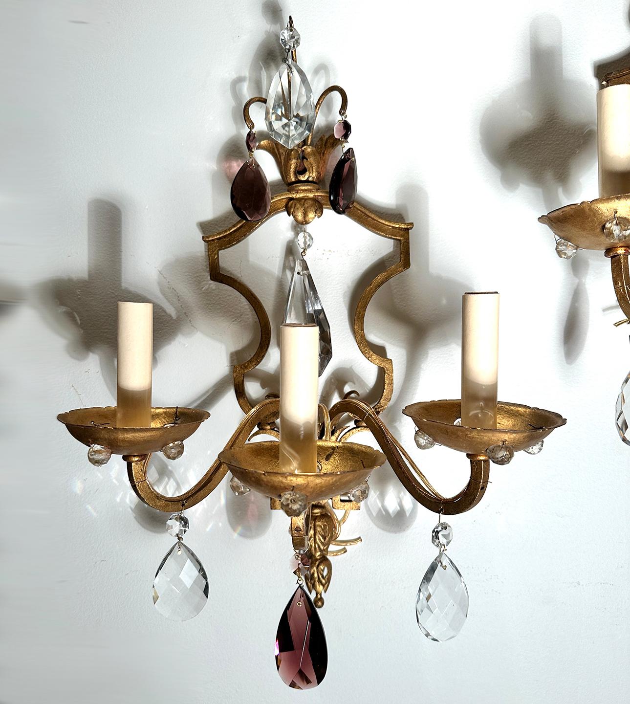 Pair of circa 1930's French gilt metal 3 light sconces with crystals.

Measurements:
Height: 19