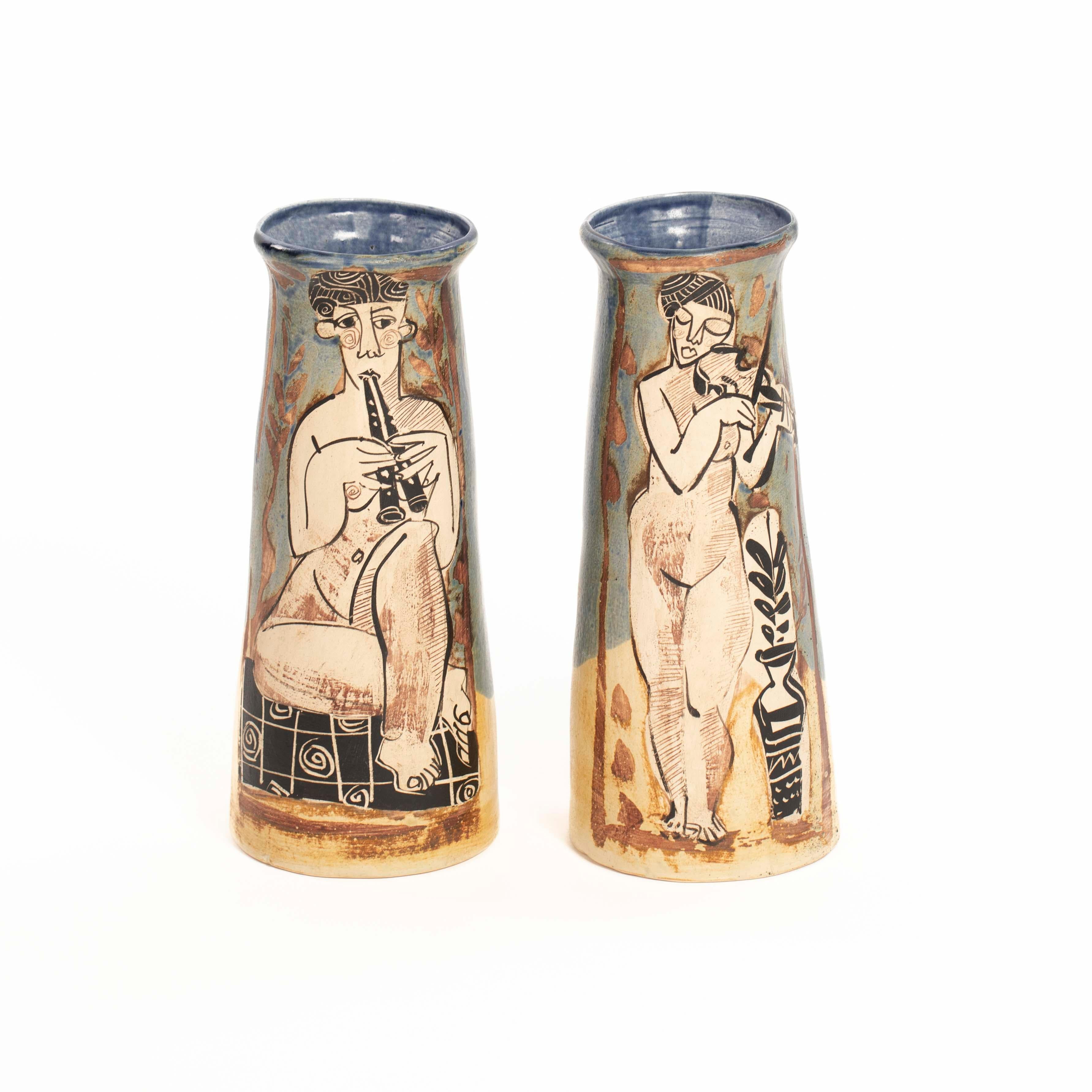 Pair of French Cubist-Inspired Ceramic Vases Depicting Women Playing Music 1940s

The vases are a real feast for the eyes.
Slightly conical vase shape with outwardly turned rim showing
two women, standing and sitting, playing music.
One plays the