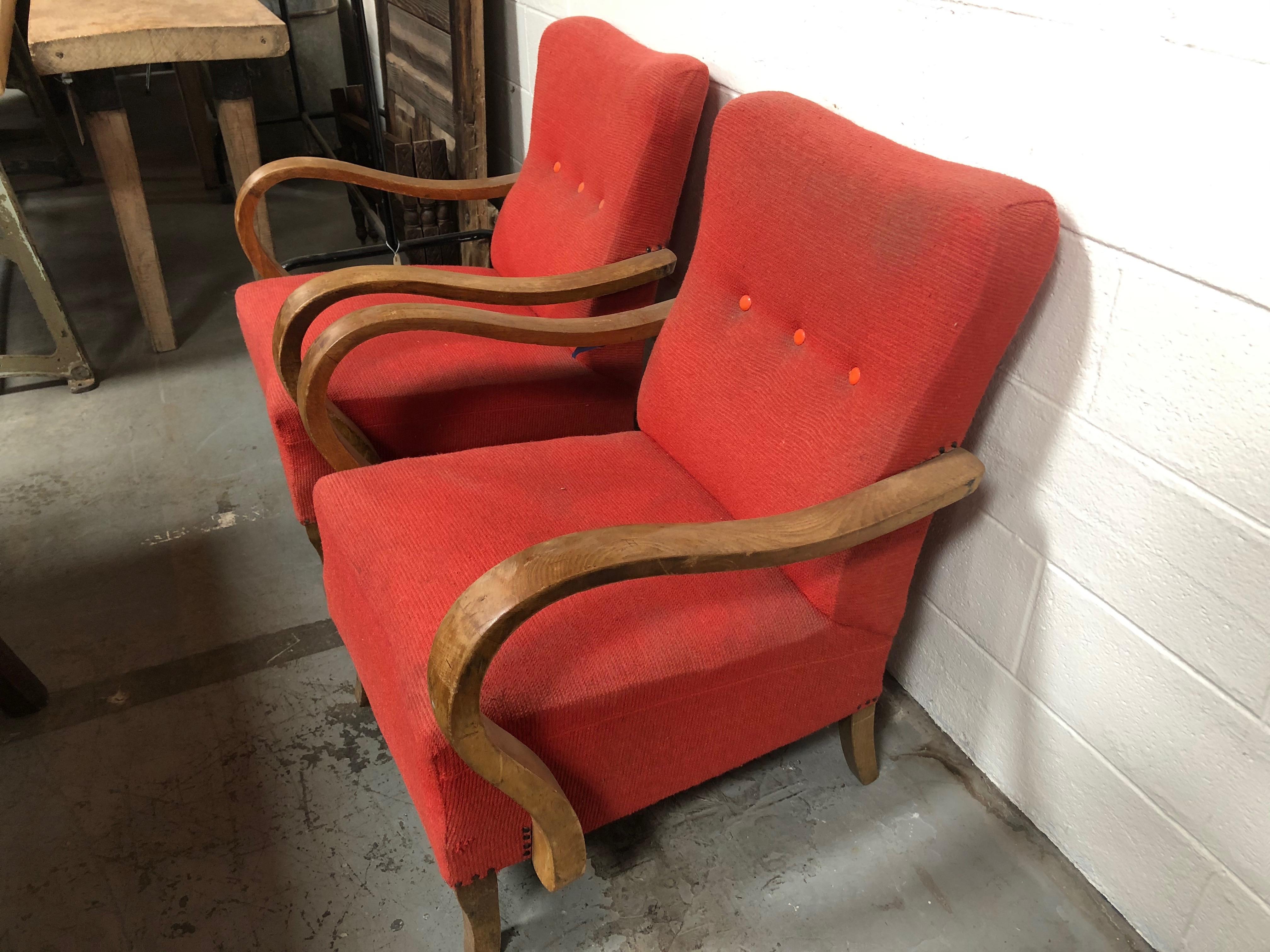 This set of red deco chairs are from France and feature stylish curved wooden arm rests and wooden legs.